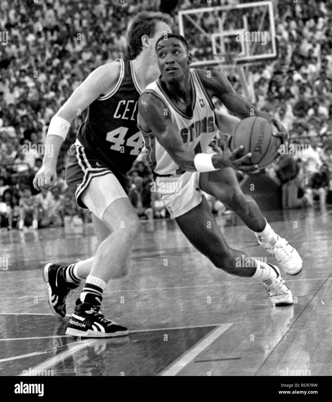Game action Detroit Pistons Isiah Thomas charges past Boston Celtics Danny Ainge in the Detroit Michigan USA 1988 photo by bill belknap Stock Photo