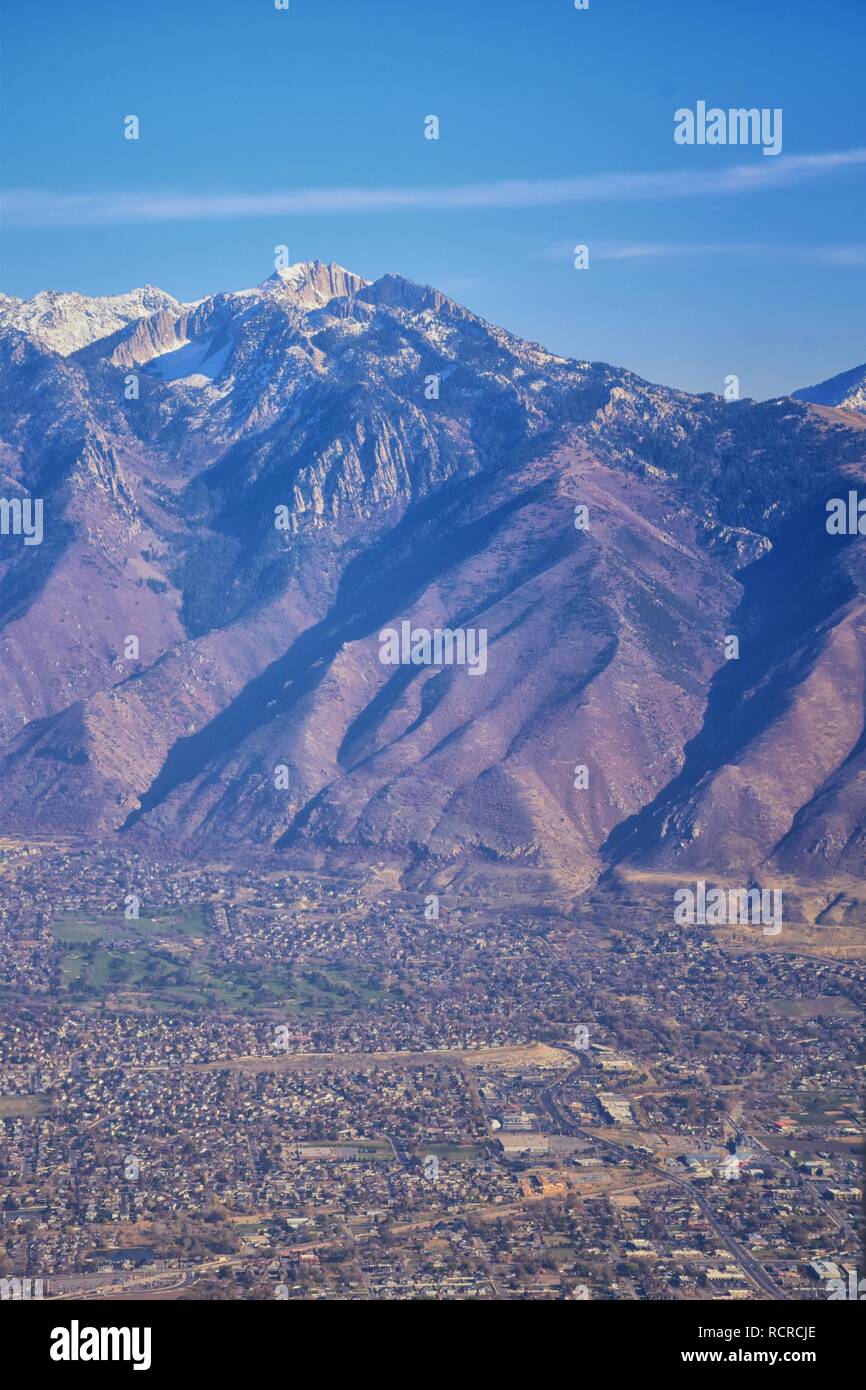 Aerial view of Wasatch Front Rocky Mountain landscapes on flight over Colorado and Utah during winter. Grand sweeping views near the Great Salt Lake, Stock Photo