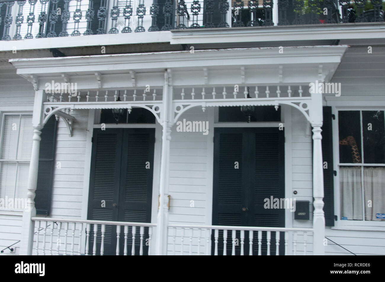 Savannah, GE: 10/19/18: Black door shutters and decorative porch railing woodwork on house in Savannah, GA Stock Photo