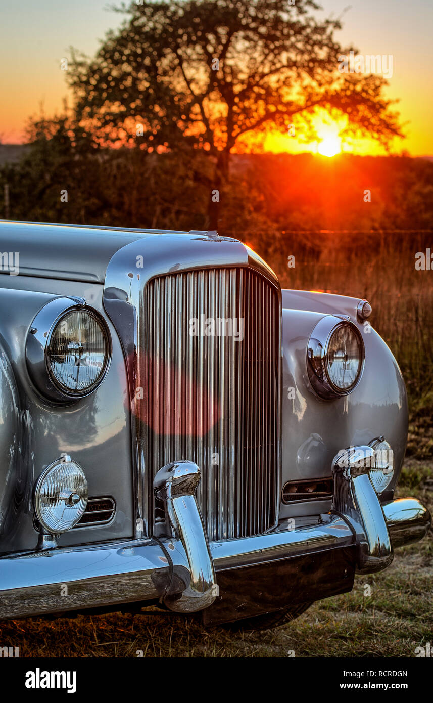 Luxury two toned vintage car on a Texas country road at sunset Stock Photo