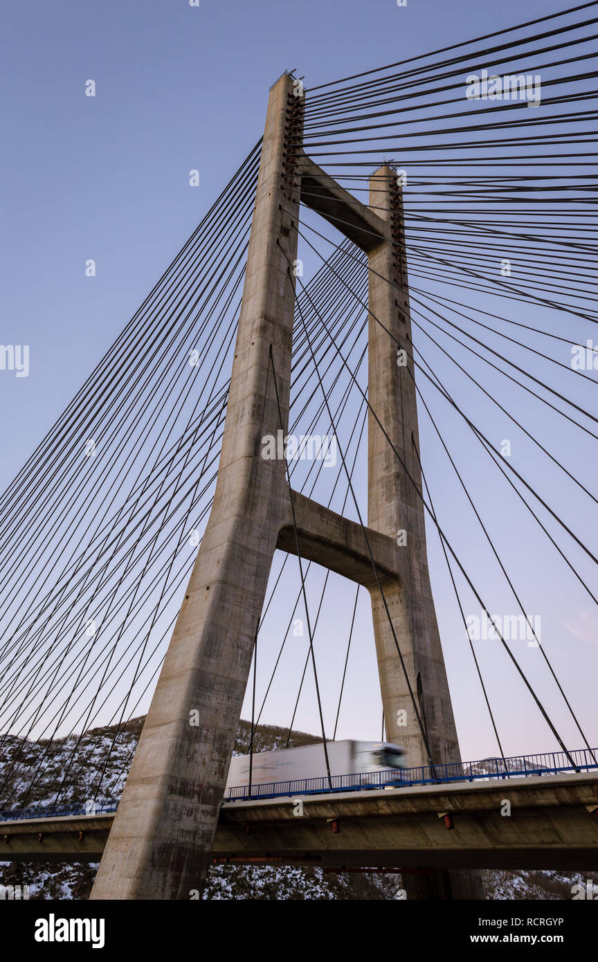 Modern cement bridge pylon structure over clear blue sky Stock Photo