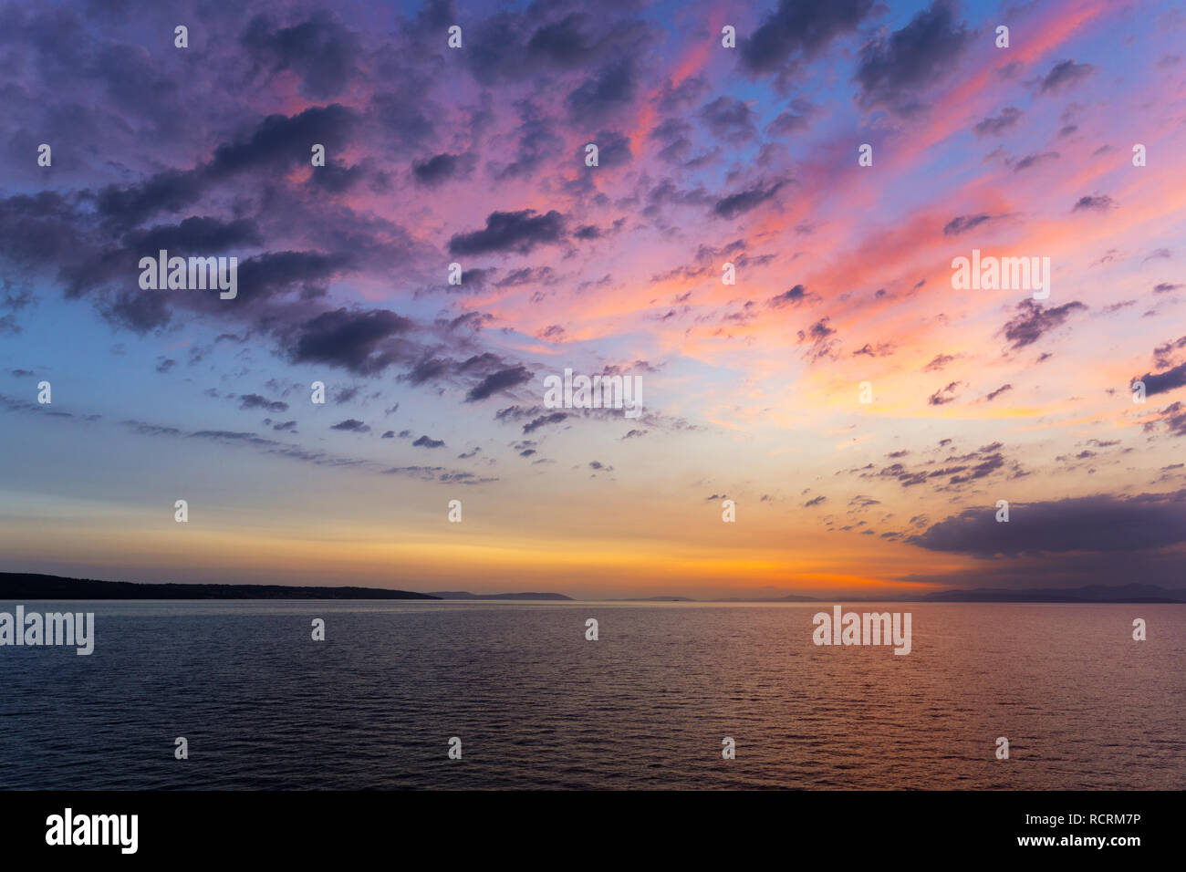 Sunset or sunrise sky above the sea. Nature, weather, atmosphere, travel theme. Sunrise or sunset over the sea. Panorama Stock Photo