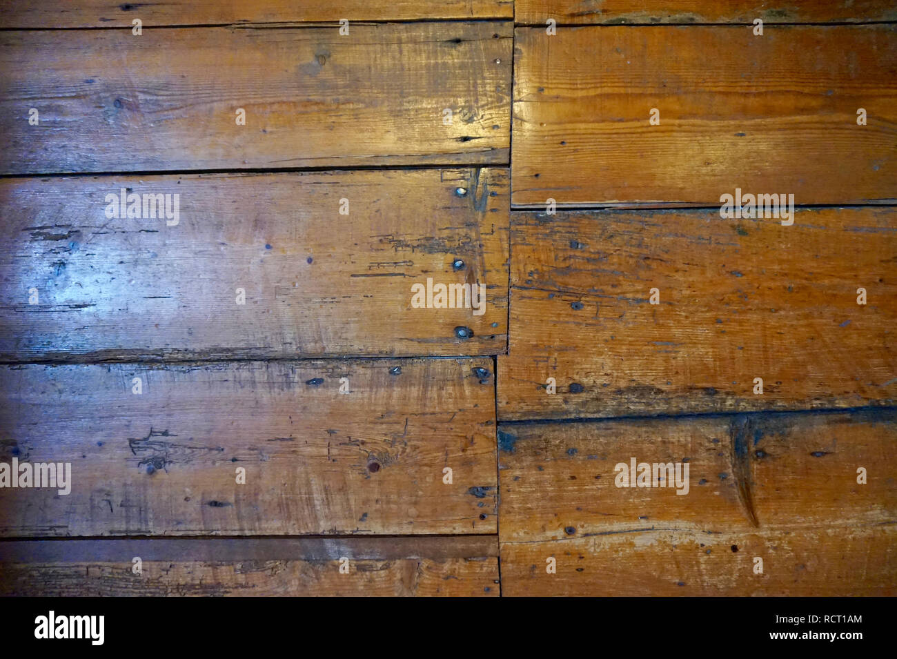 Old Wood Floors Set In An Uneven Pattern With Nails Showing Some