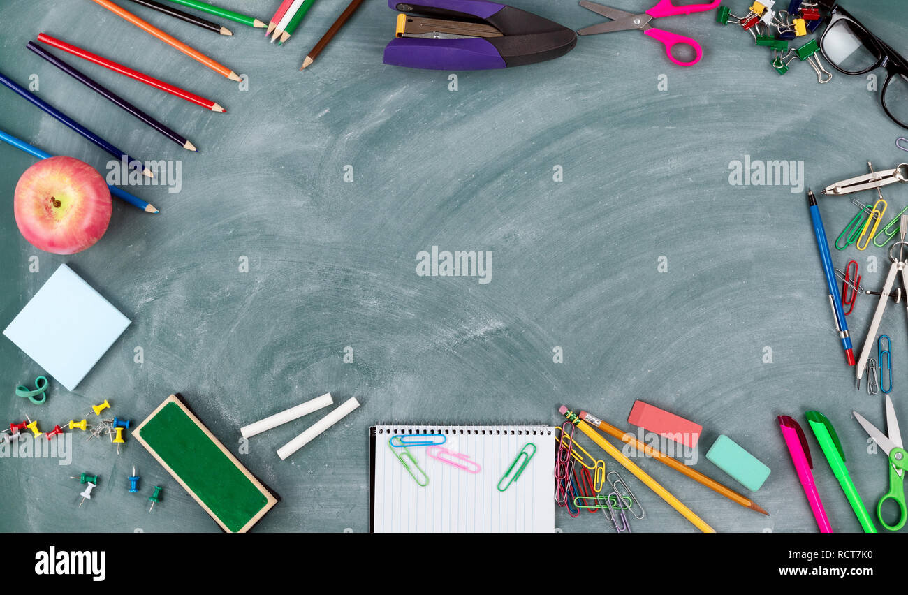 Back to school concept with green erased chalkboard and a variety of ...
