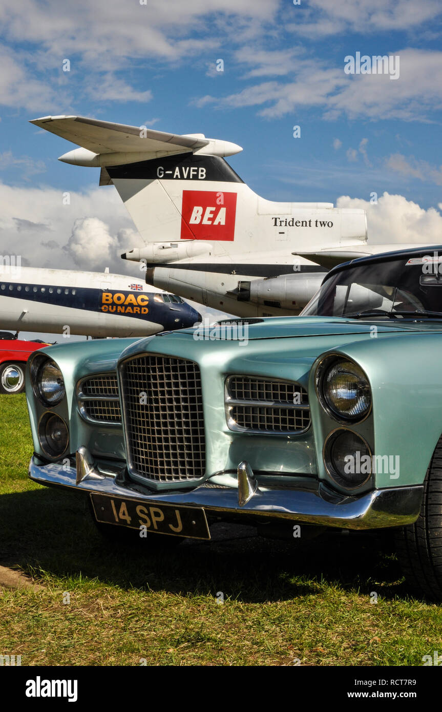 Vintage plane and car. Classic airliner BEA Hawker Siddeley Trident Two and BOAC Cunard Vickers VC10. 1960 Facel Vega HK500 classic French vehicle Stock Photo