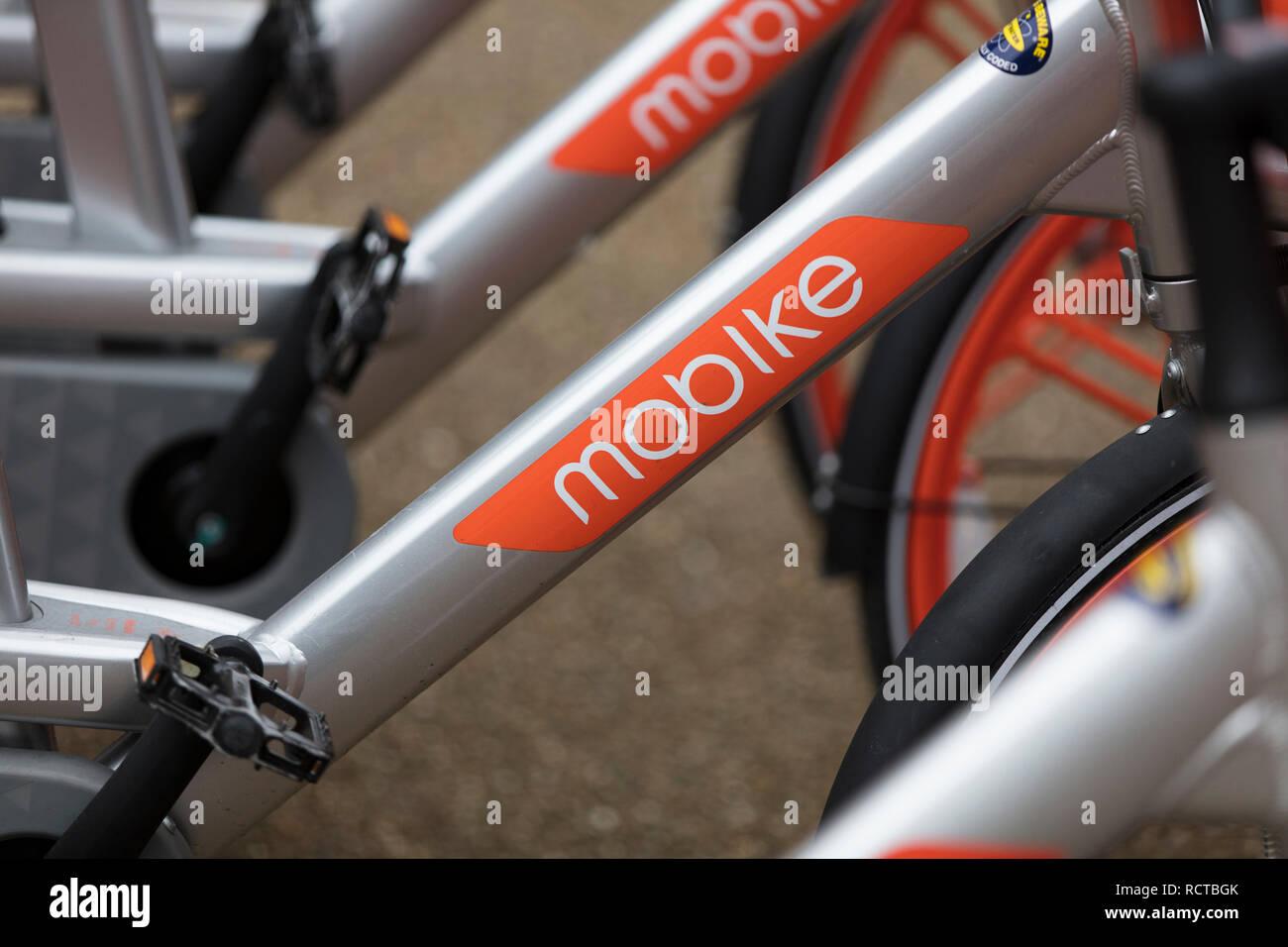 LONDON, ENGLAND - JANUARY 15, 2019: Mobike dockless bicycles parked in a street. Mobike is a bike sharing platform for short distance travel. Stock Photo