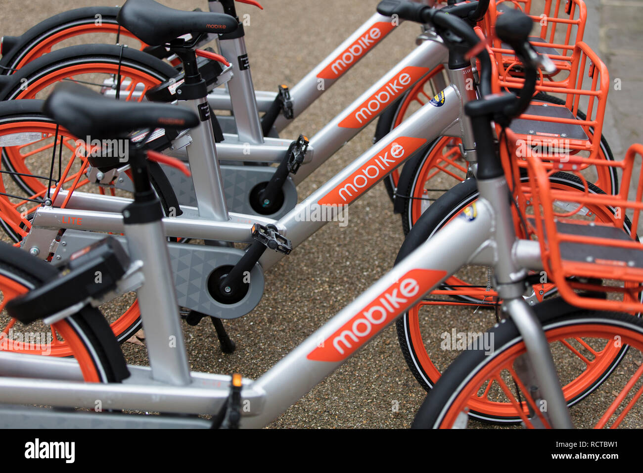 LONDON, ENGLAND - JANUARY 15, 2019: Mobike dockless bicycles parked in a street. Mobike is a bike sharing platform for short distance travel. Stock Photo