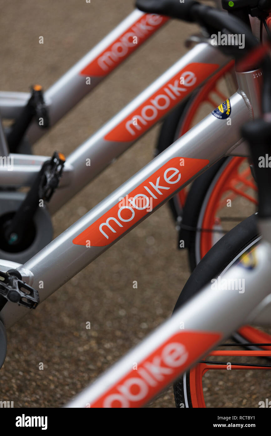 LONDON, ENGLAND - JANUARY 15, 2019: Mobike dockless bicycles parked in a street. Mobike is a bike sharing platform for short distance travel. Stock Photo