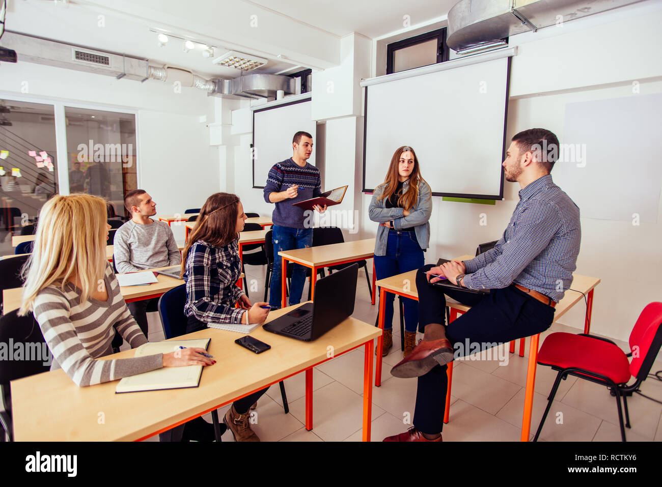 Students are standing in the classroom and having a presentation with ...