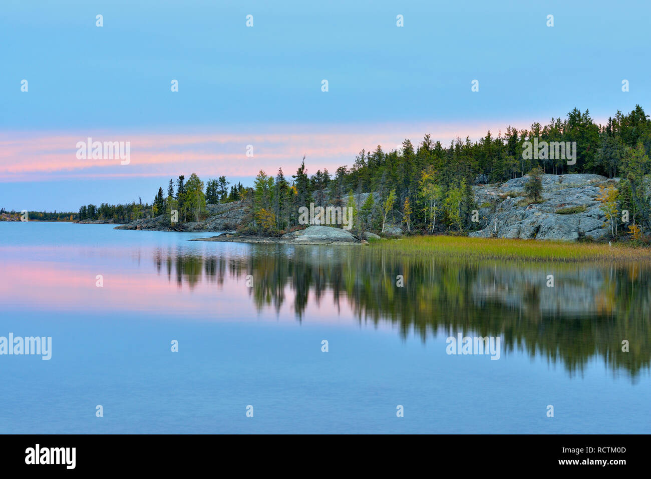 Sunset sky reflections in Long Lake, Fred Henne Territorial Park, Northwest Territories, Northwest Territories, Canada Stock Photo