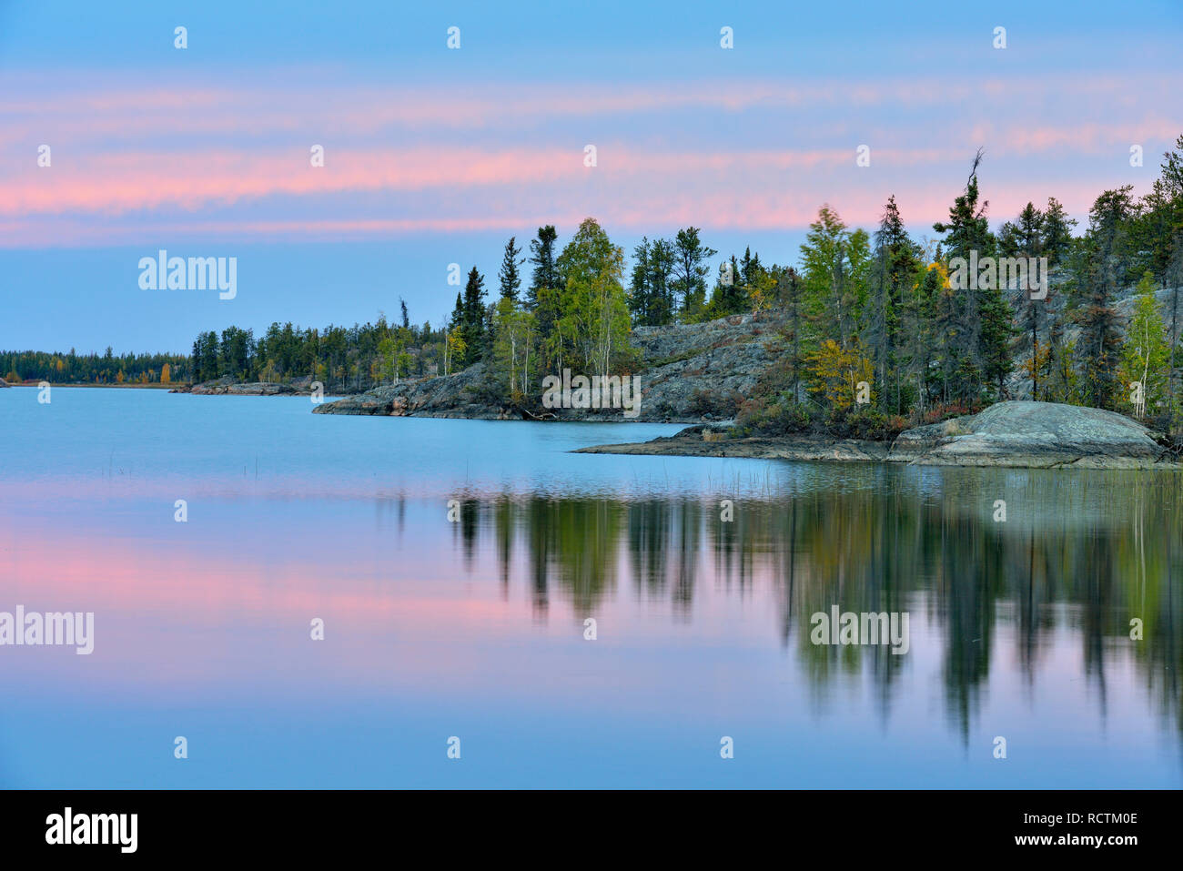 Sunset sky reflections in Long Lake, Fred Henne Territorial Park, Northwest Territories, Northwest Territories, Canada Stock Photo