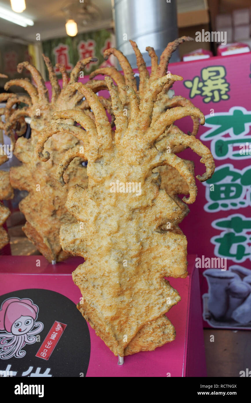 New Taipei, Taiwan - November 24, 2018: The famous Taiwanese fried squid in Tamsui old street, New Taipei, Taiwan. Stock Photo
