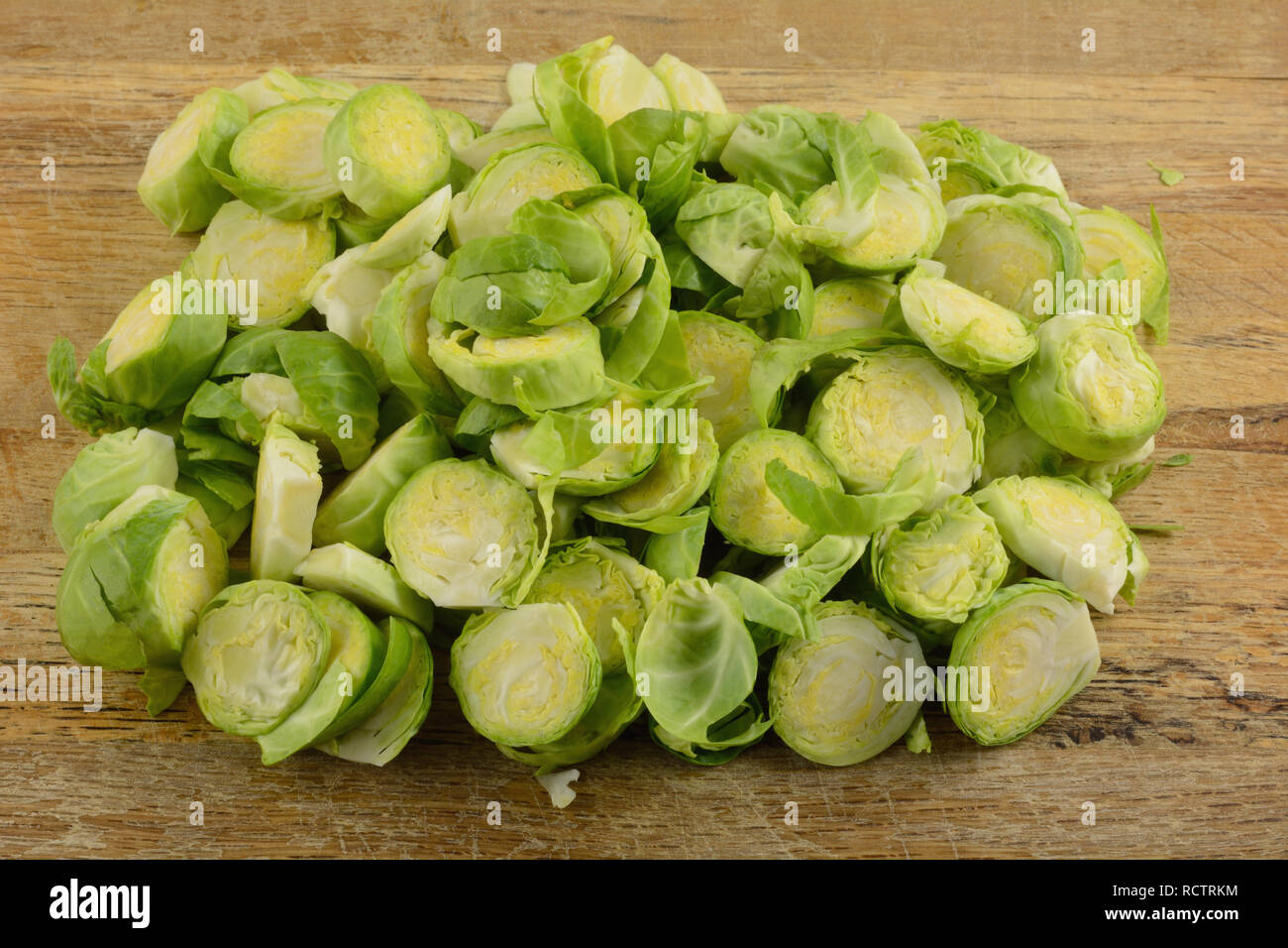 Close up of sliced fresh raw brussel sprouts on rustic cutting board Stock Photo