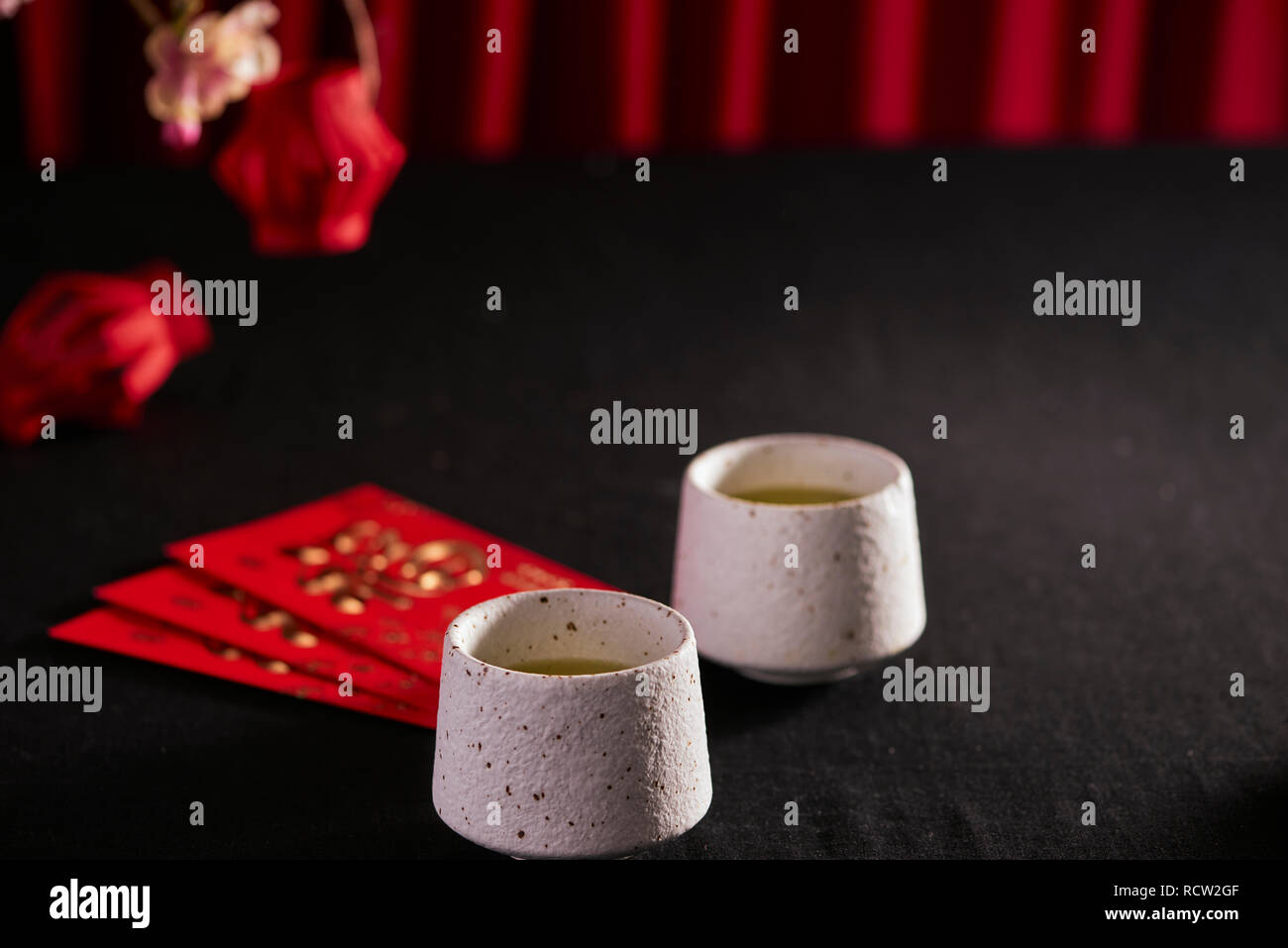Lunar new year food and drink still life on black background. Translation of text paper in image