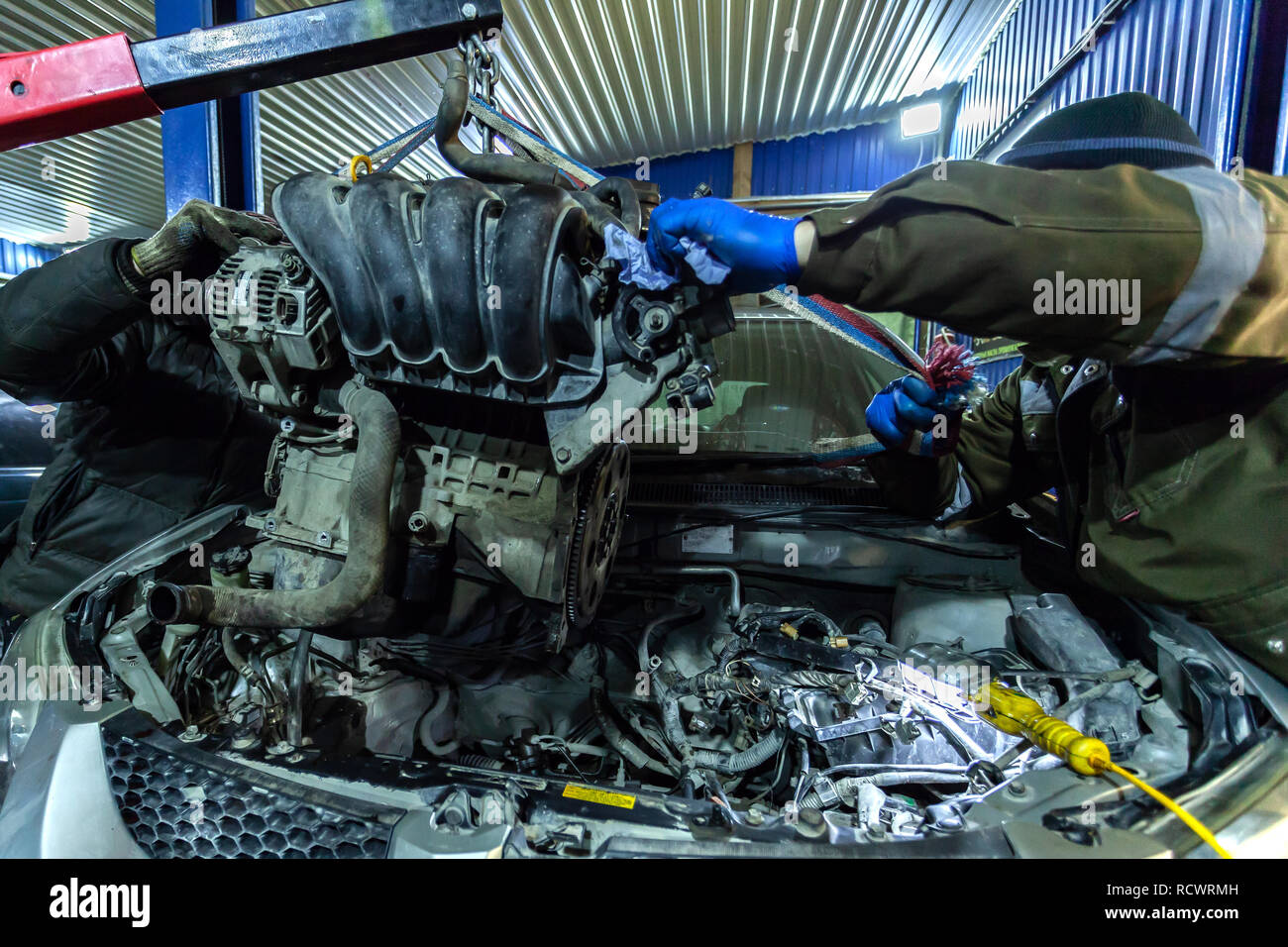 Closeup of the installation of the motor on an old car using a