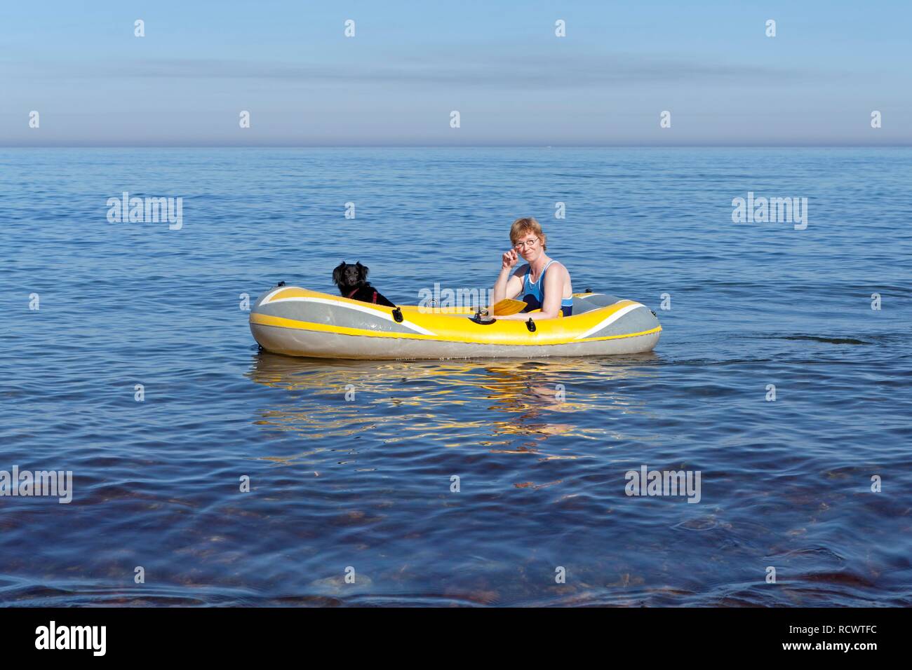 Woman with dog in a rubber boat, Kuehlungsborn-West, Mecklenburg-Western Pomerania Stock Photo