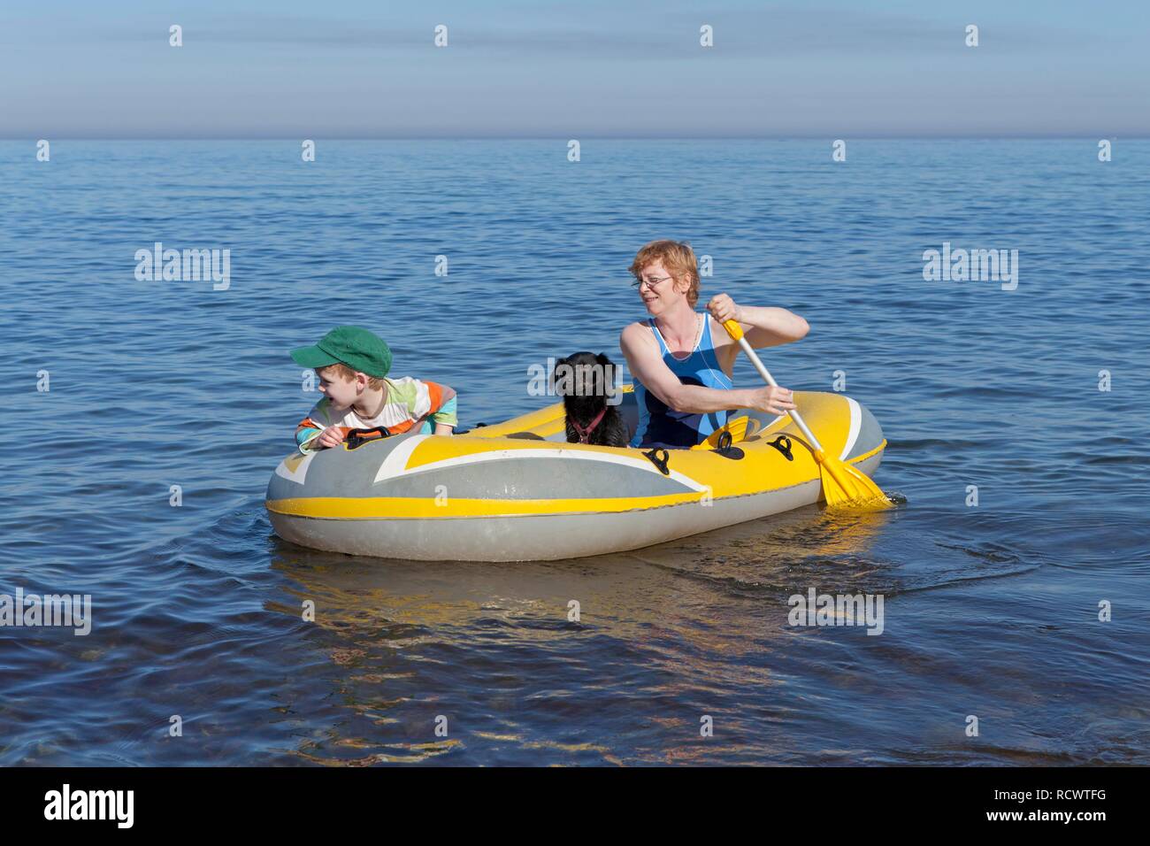Mother and son with dog in a rubber boat, Kuehlungsborn-West, Mecklenburg-Western Pomerania Stock Photo