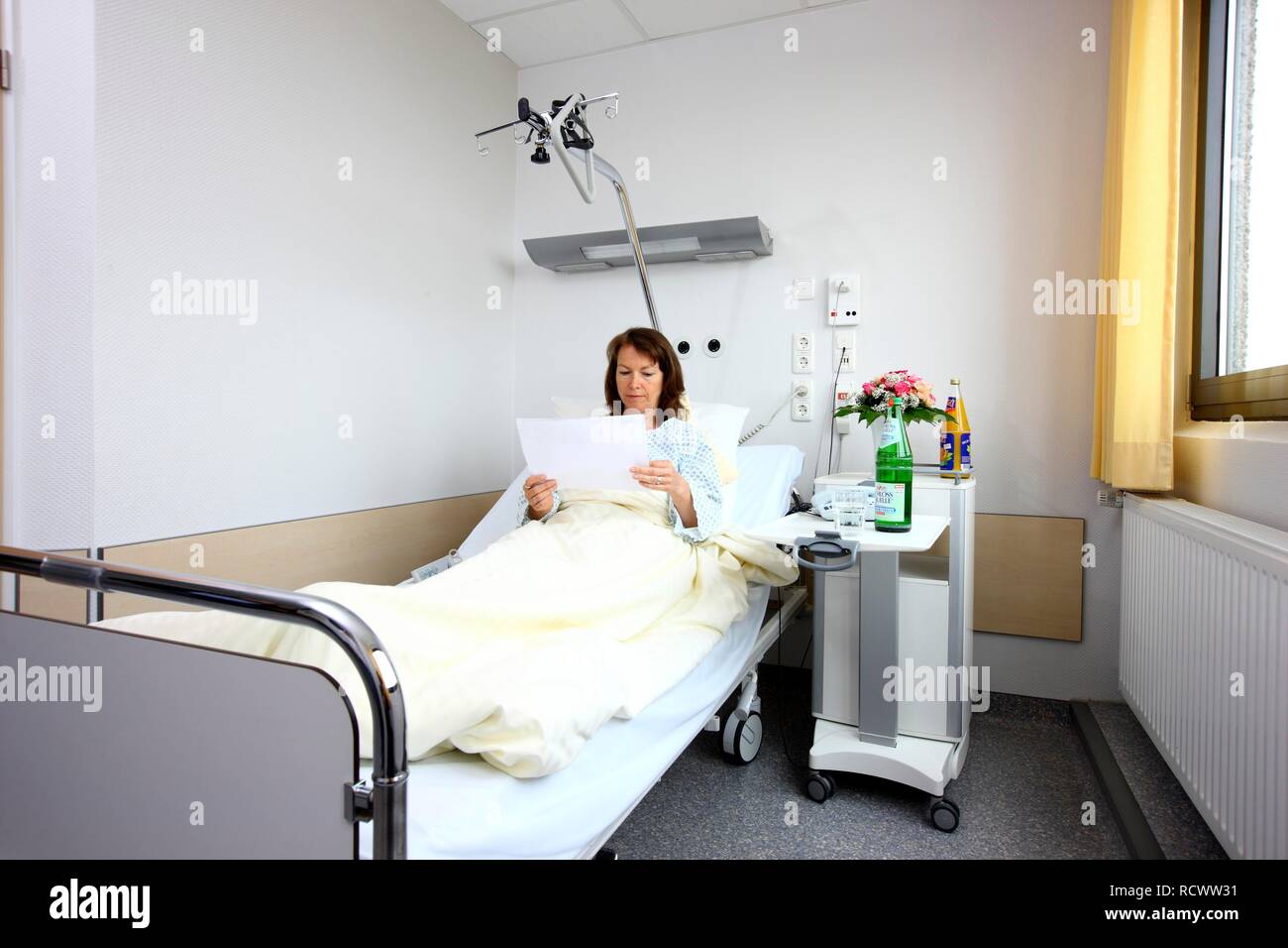 Patient lying in a hospital bed, hospital room, single room, hospital ...