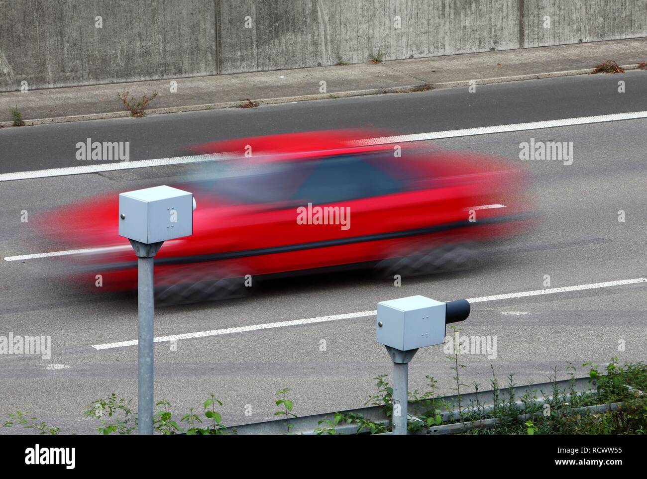 Radar controlled speed monitoring with speed cameras, on the Autobahn A44 motorway, in a 100 kilometers per hour speed-limit Stock Photo