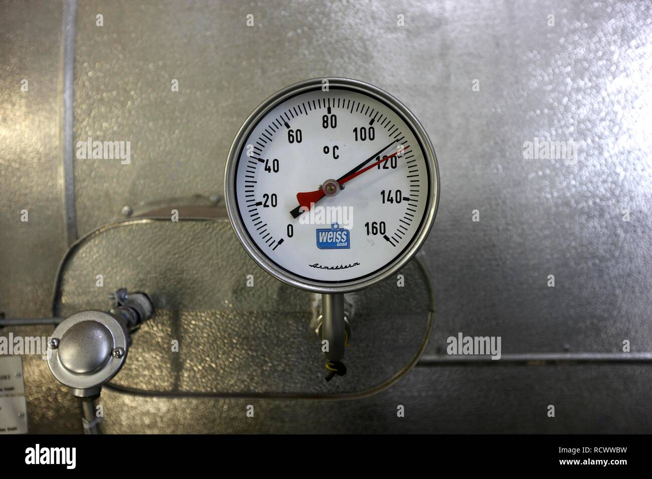 Thermometer on a hot steam boiler in the boiler house at a power plant Stock Photo