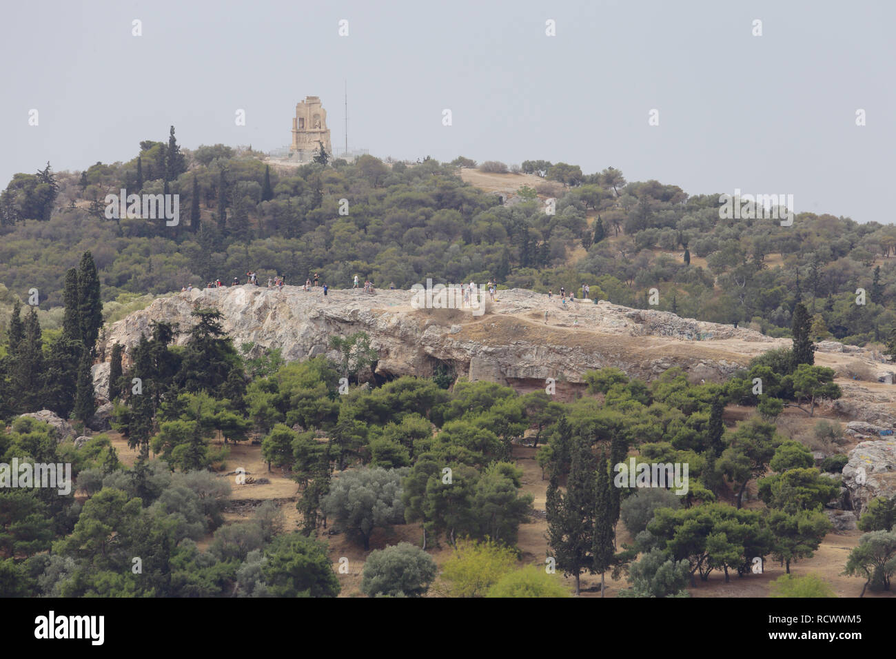 Athens, Greece - June 6, 2016: Areopagus Hill, with the Monument of Philopappos in the background, are shown during an afternoon day. Stock Photo