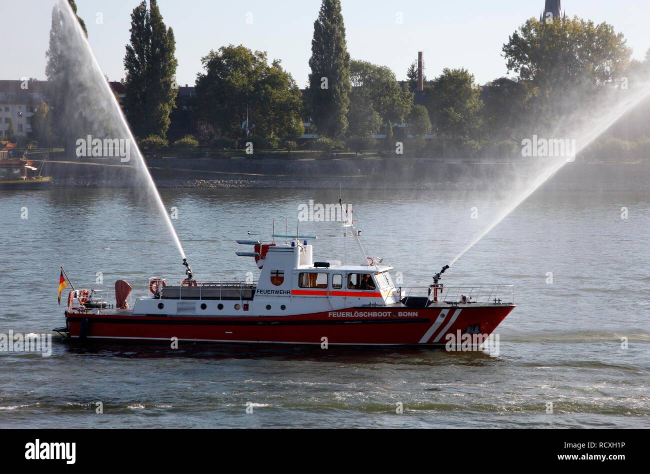 Fire fighting boat of the Bonn fire brigade on the Rhine with water jets from two cannon during a display, Bonn Stock Photo