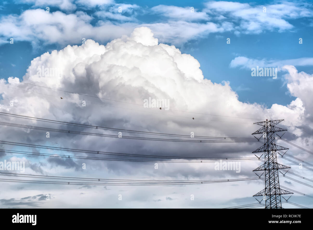 The blue cloudy sky and the high voltage Stock Photo - Alamy