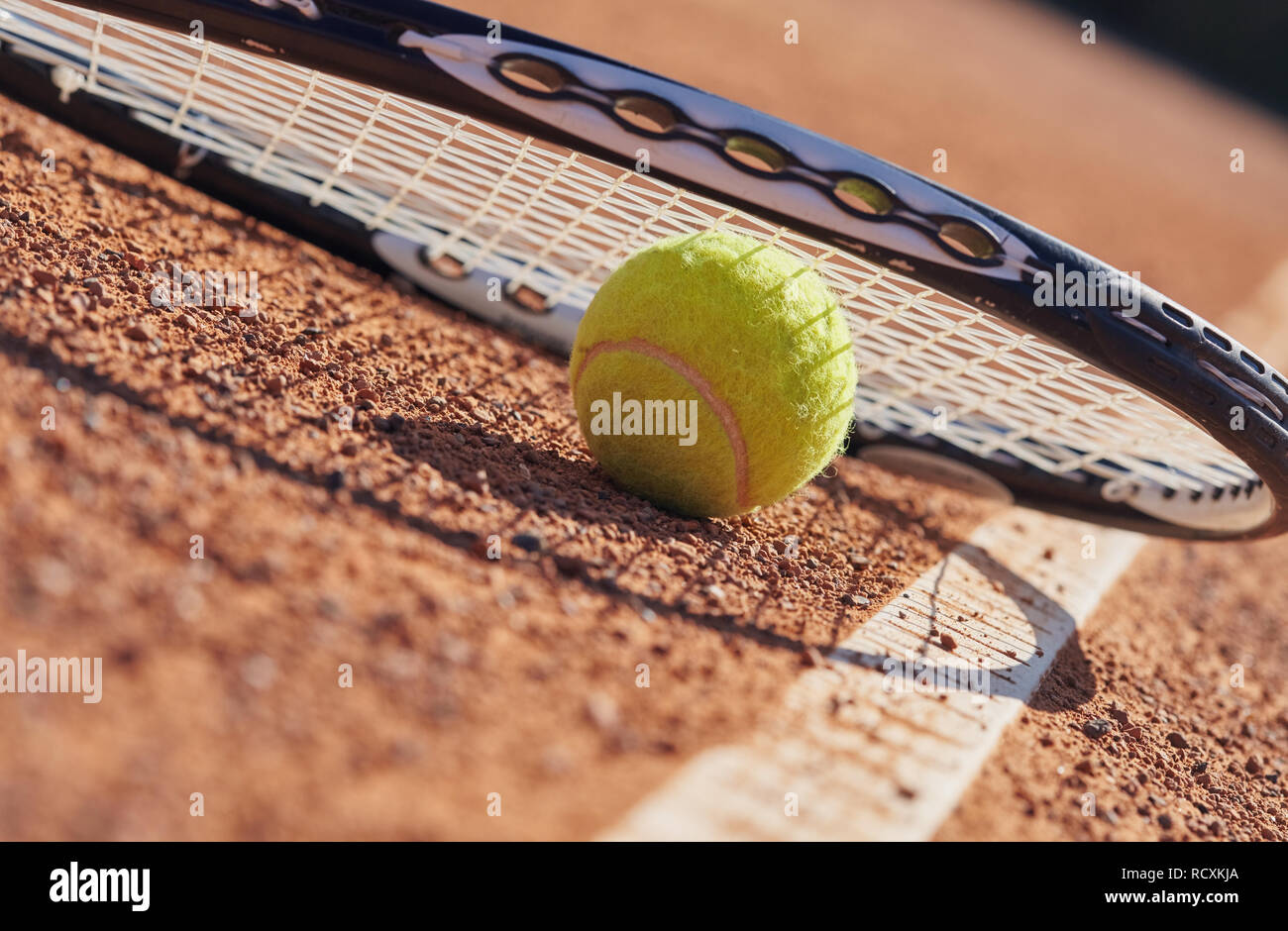 Tennis balls and racket on the court Stock Photo