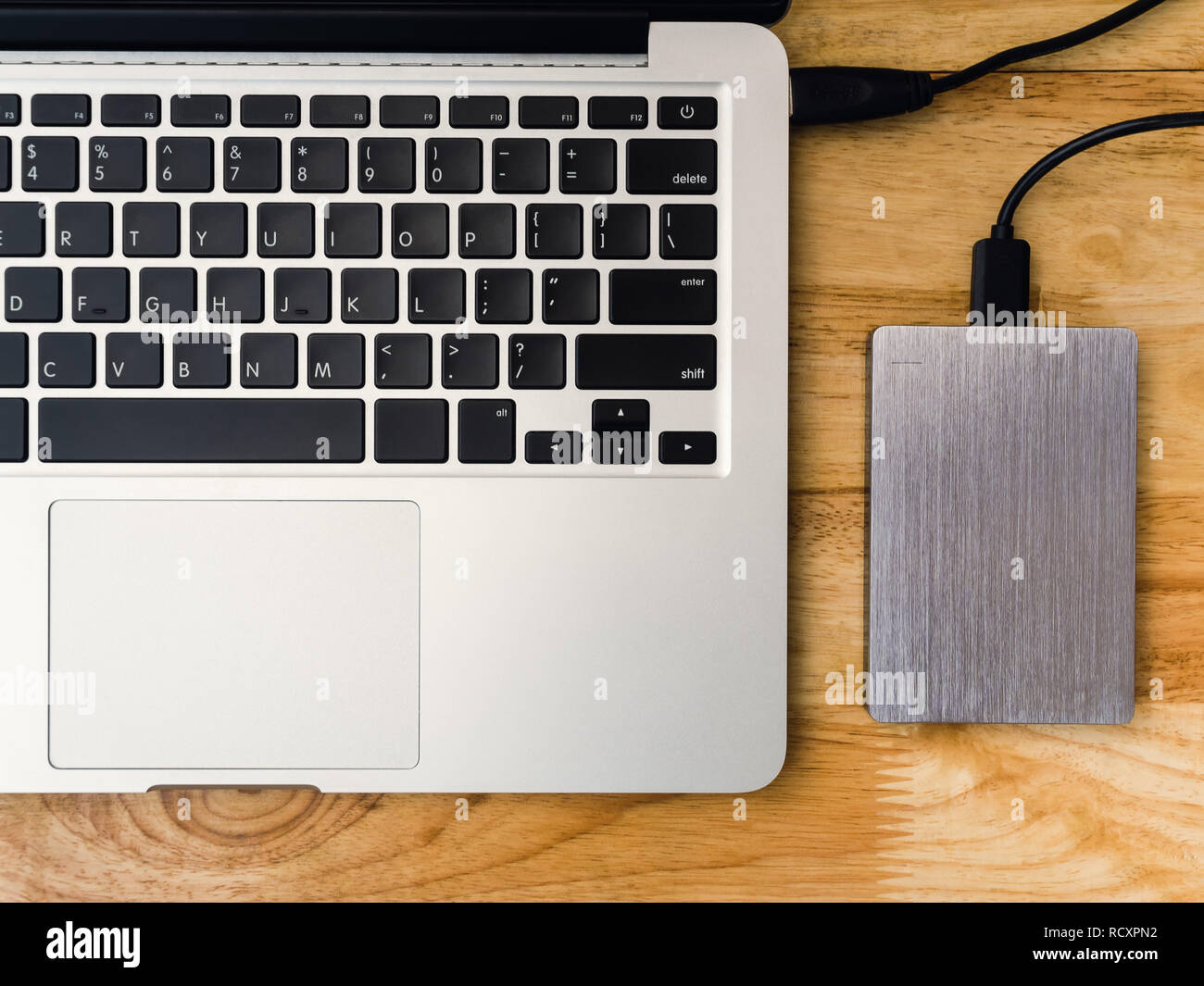 Top view of external or portable hard drive (HDD) connected to laptop