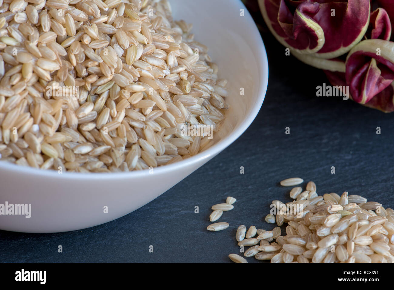 Slate Rice a bowl full of brown rice on a slate board with radicchio trevisano ...