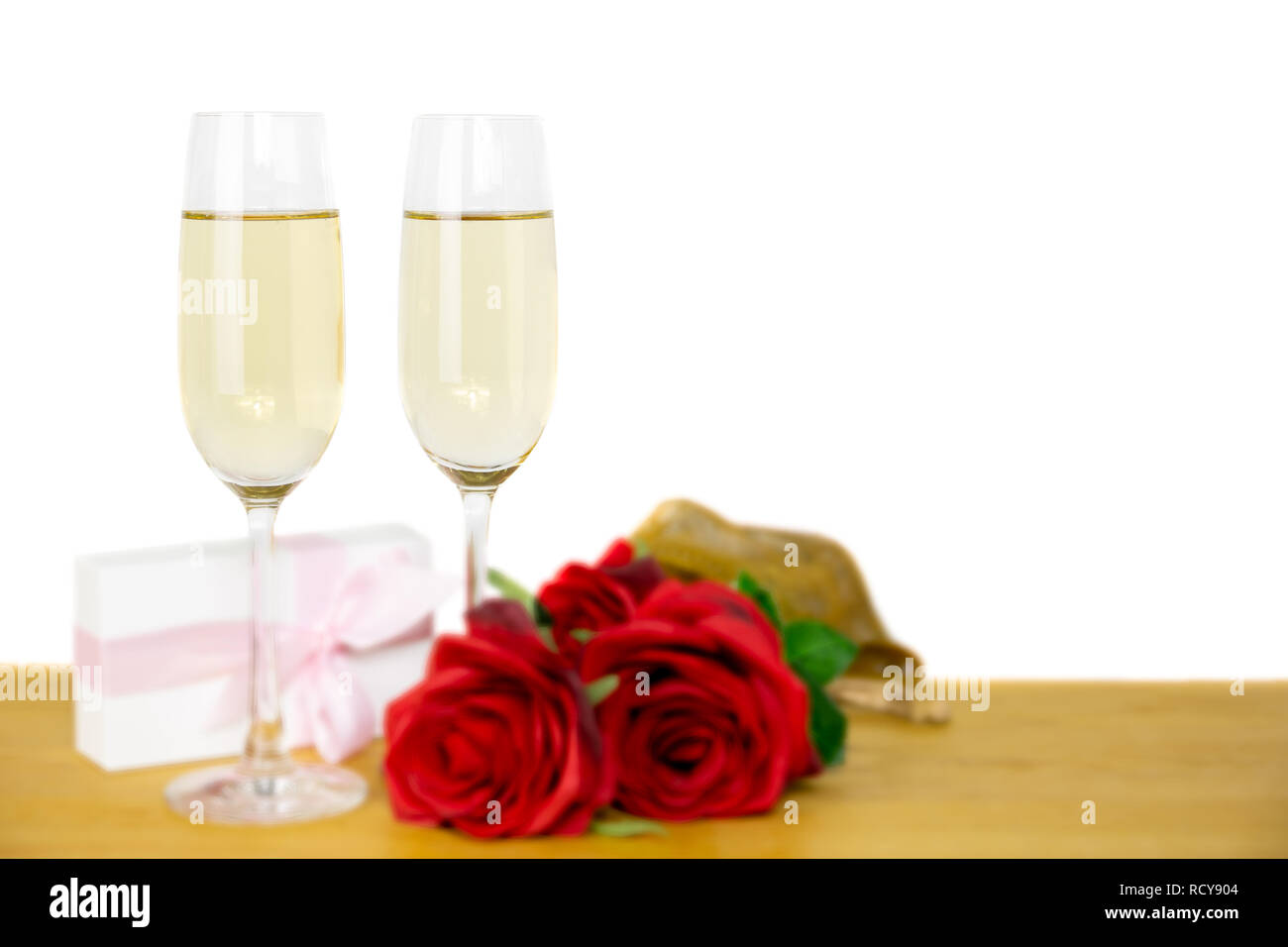 Glasses of champagne and rose flower with Valentines day gift box ...