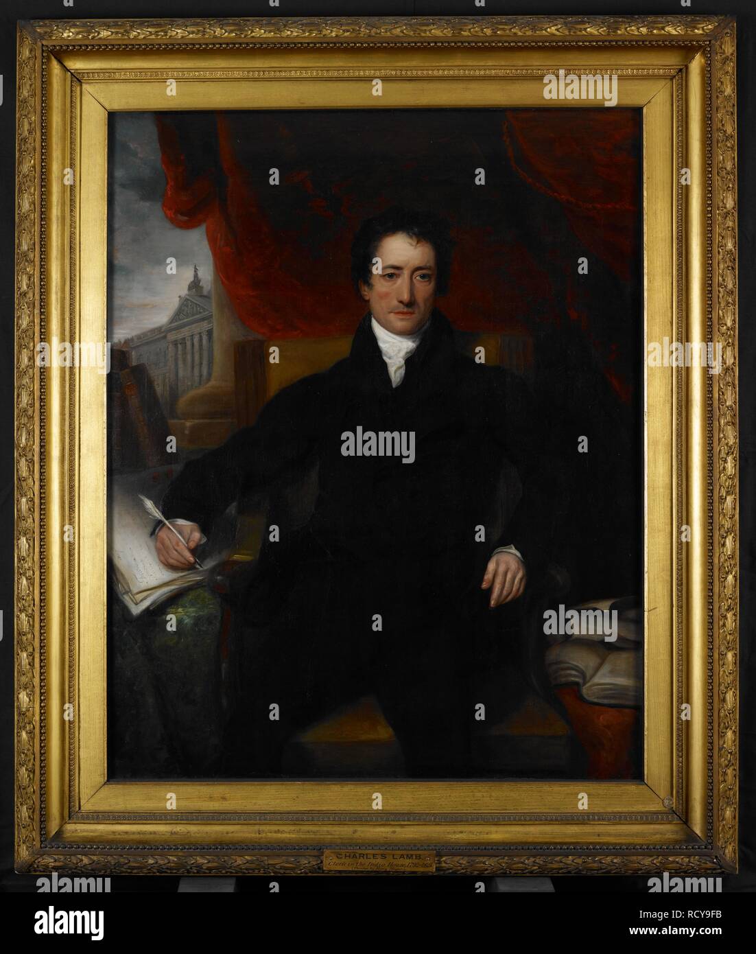 Charles Lamb (1775-1834), clerk in the East India House 1792-1825, 1826 A seated figure, three-quarter length, dressed in black. The right hand, holding a pen, rests upon a number of official documents. Behind are two volumes, one of which is labelled â€˜Eliaâ€™. A red curtain forms the background, and in the distance is seen the front of the East India House. 1826. Oil painting. (127.6 by 102.5 cms). Source: Foster 107. Author: MEYER, HENRY. Stock Photo