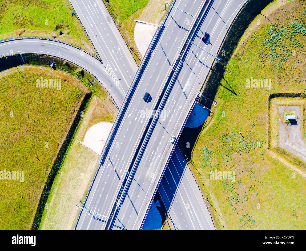 Aerial view of highway in city. Cars crossing interchange overpass ...