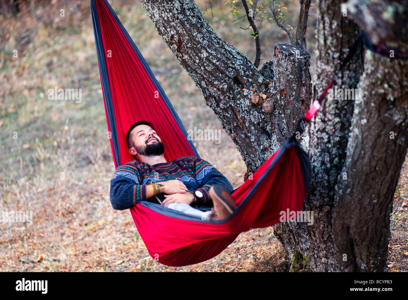Man lying in a hammock and relaxing in the nature Stock Photo