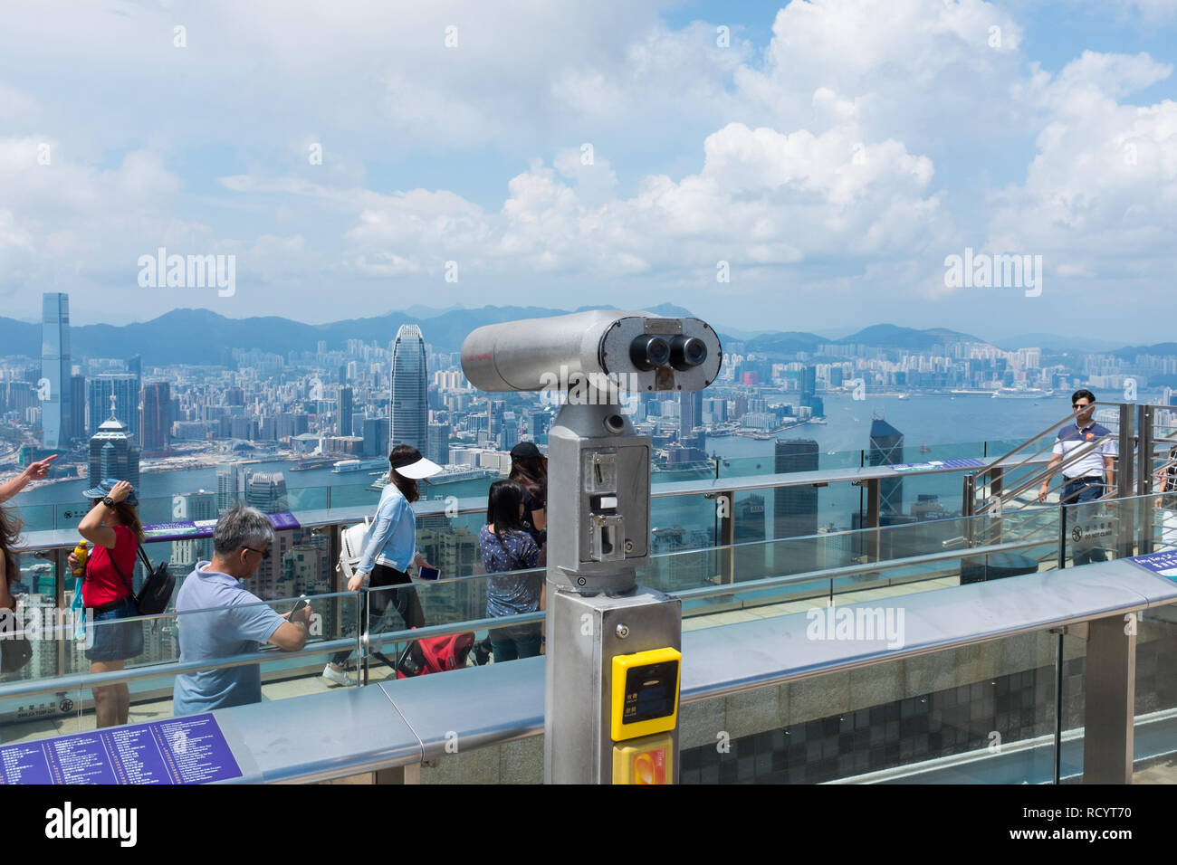 Visitors on the viewing platform at the top of Victoria Peak also known as The Peak on Hong Kong Island looking down at the view Stock Photo