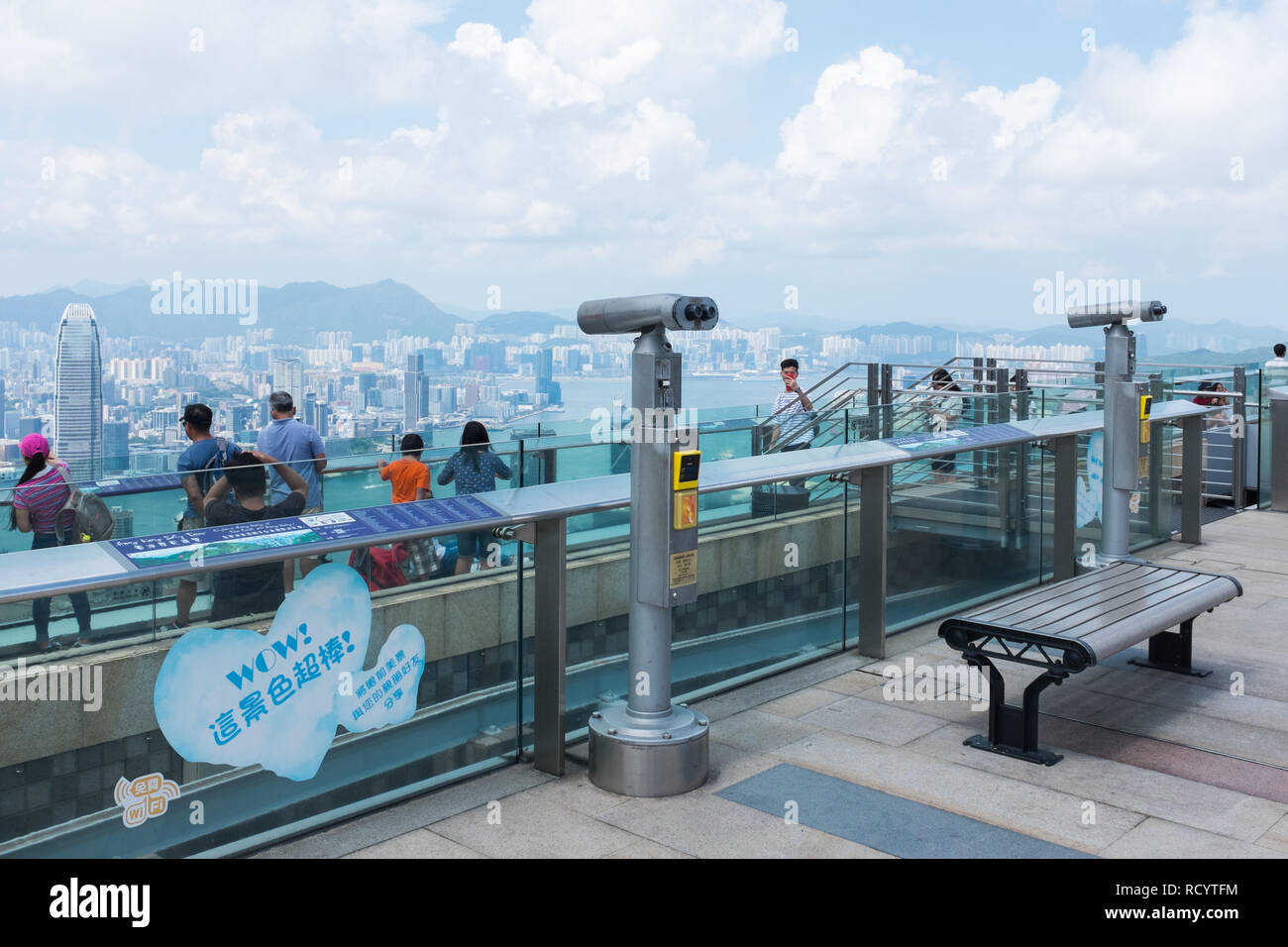 Visitors on the viewing platform at the top of Victoria Peak also known as The Peak on Hong Kong Island looking down at the view Stock Photo