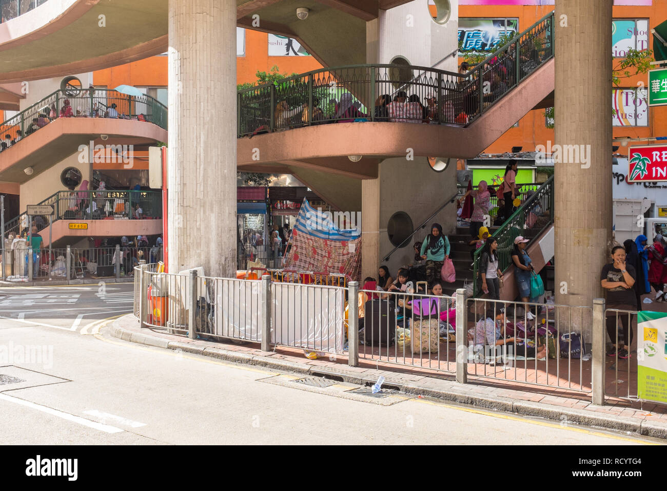 Domestic workers from the Phillipines congregate with friends on their day off,sunday, in the Central district of Hong Kong Stock Photo