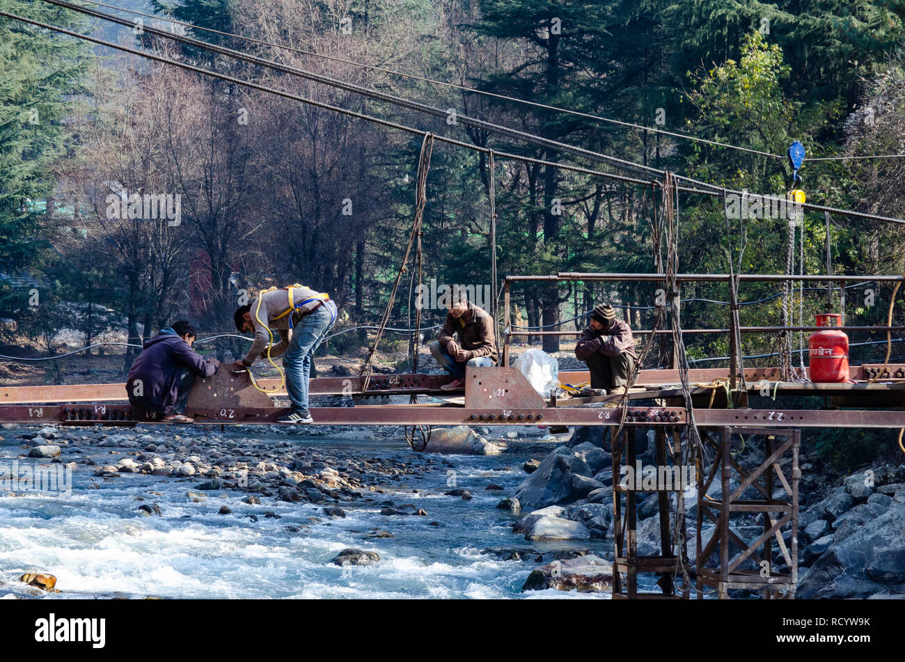 Repairing a footover bridge at Kasol. This joins the Chalal and Rashol village. Stock Photo