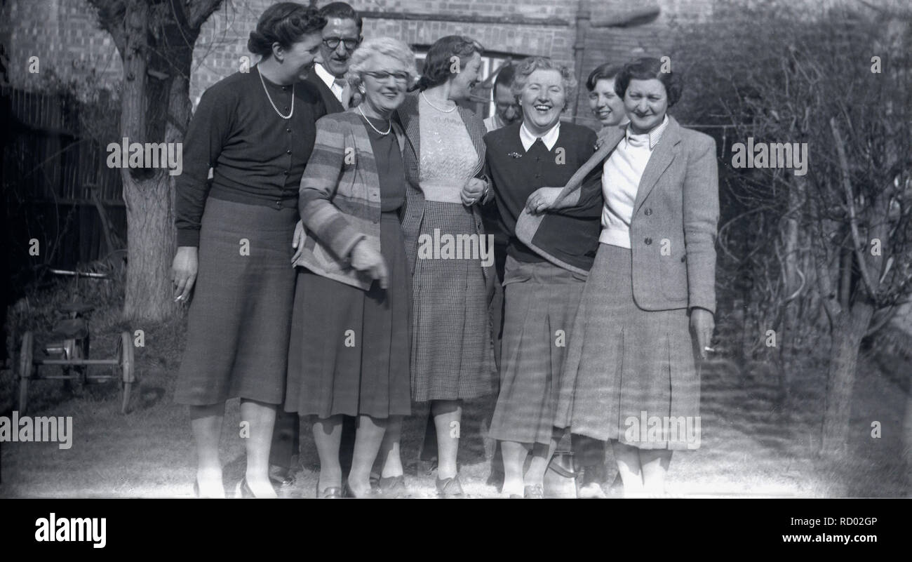 1930s, historical,  group of ladies standing together outside in a garden having a laugh and a cigarette, England, UK. Stock Photo