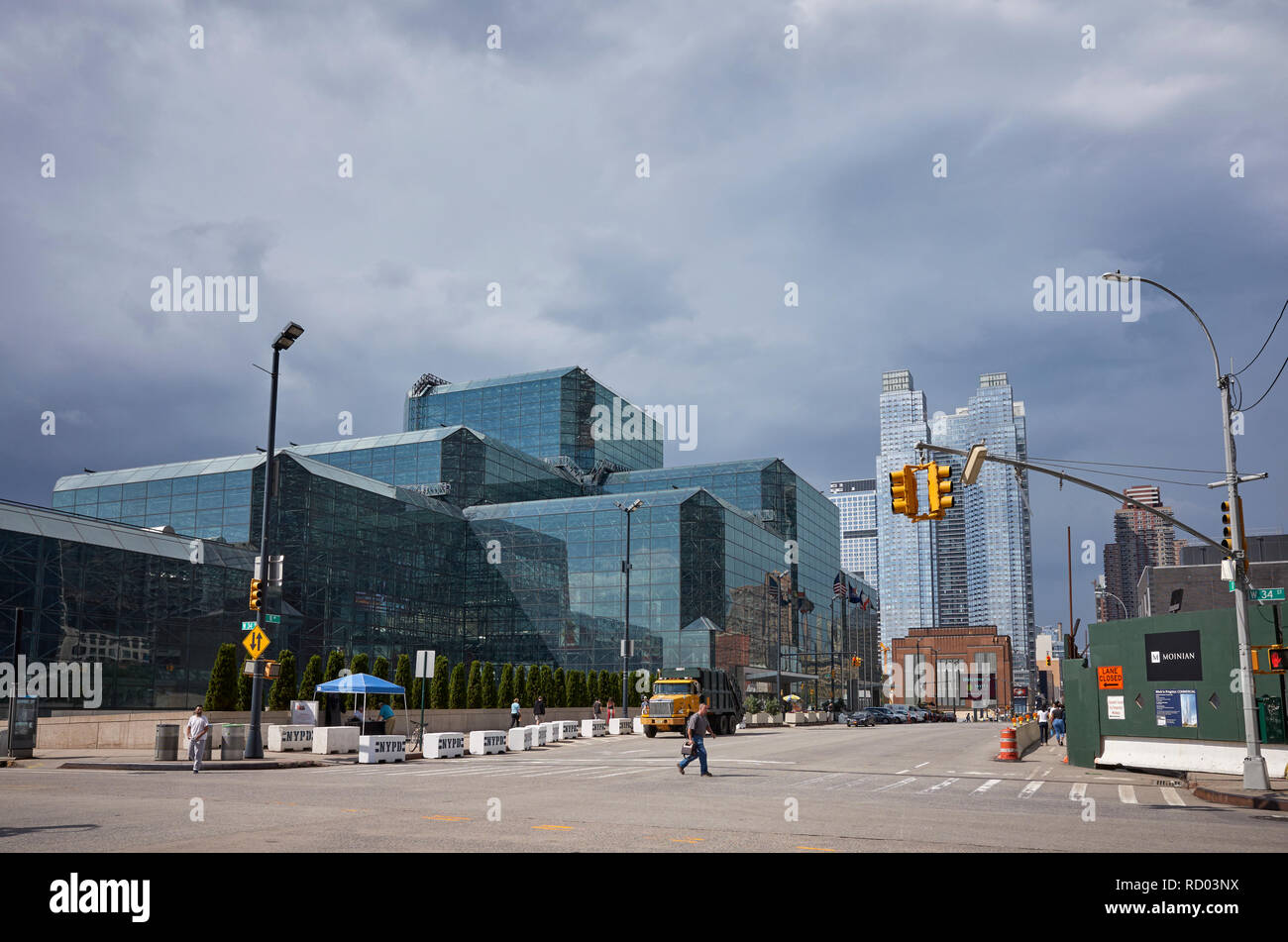 New York, USA - June 28, 2018: Pedestrian crosses intersection at the Jacob K. Javits Convention Center, commonly known as the Javits Center. Stock Photo