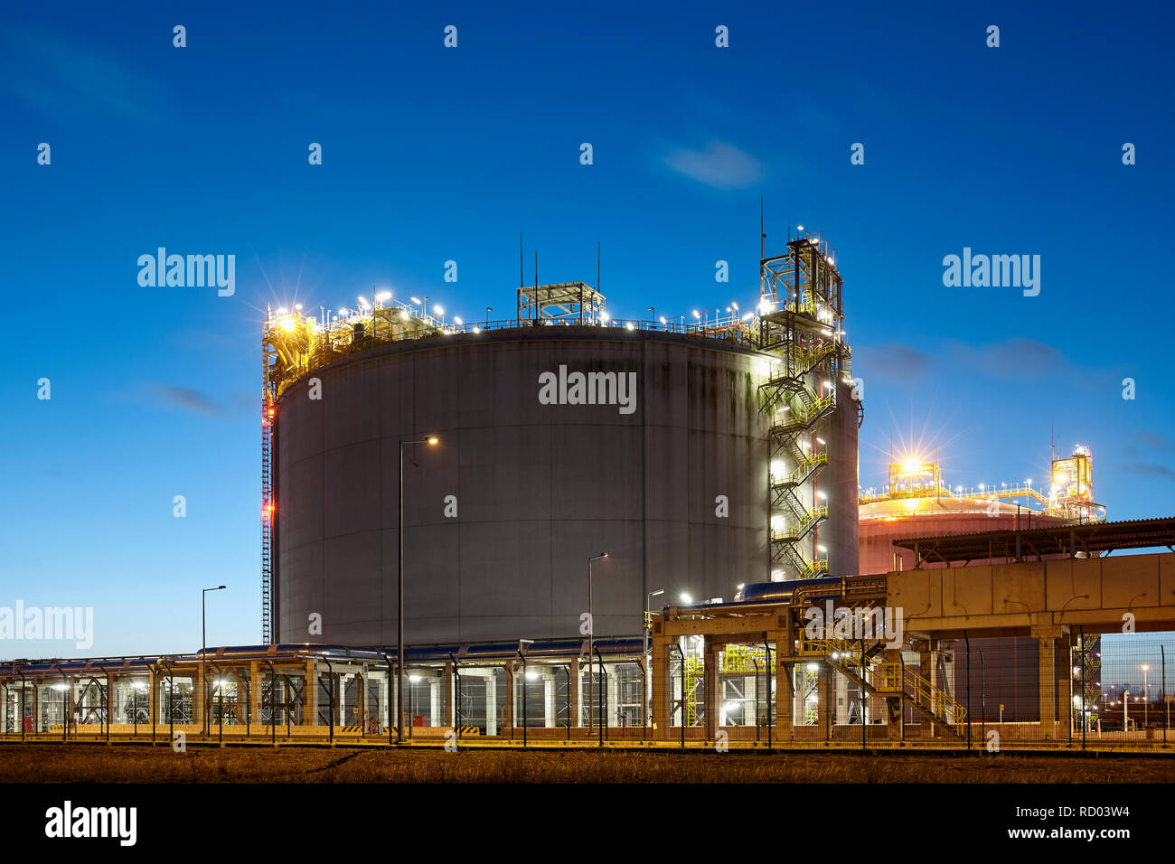 Liquefied natural gas (LNG) storage tank at dusk. Stock Photo