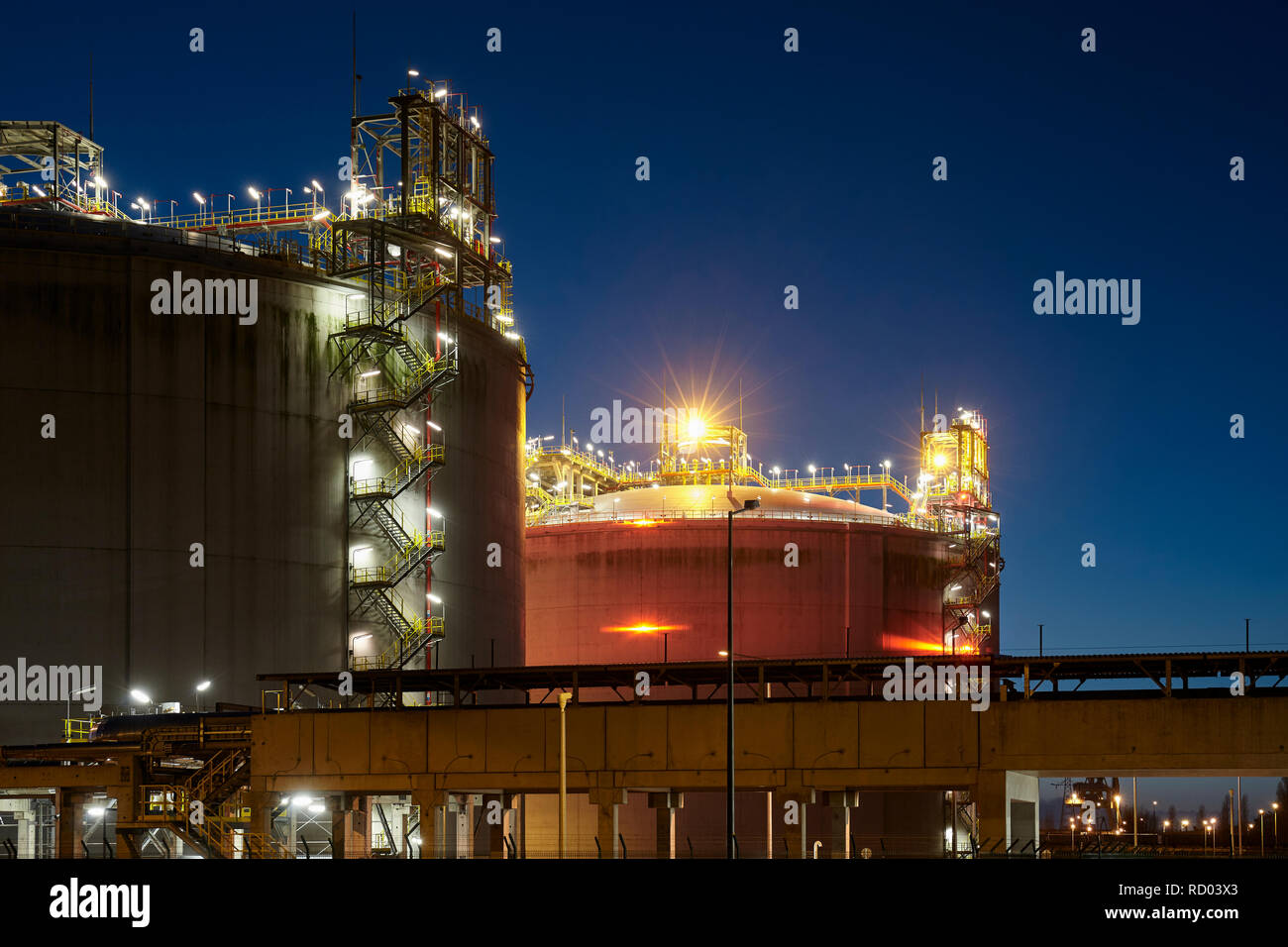 Liquefied natural gas (LNG) storage tanks at night. Stock Photo