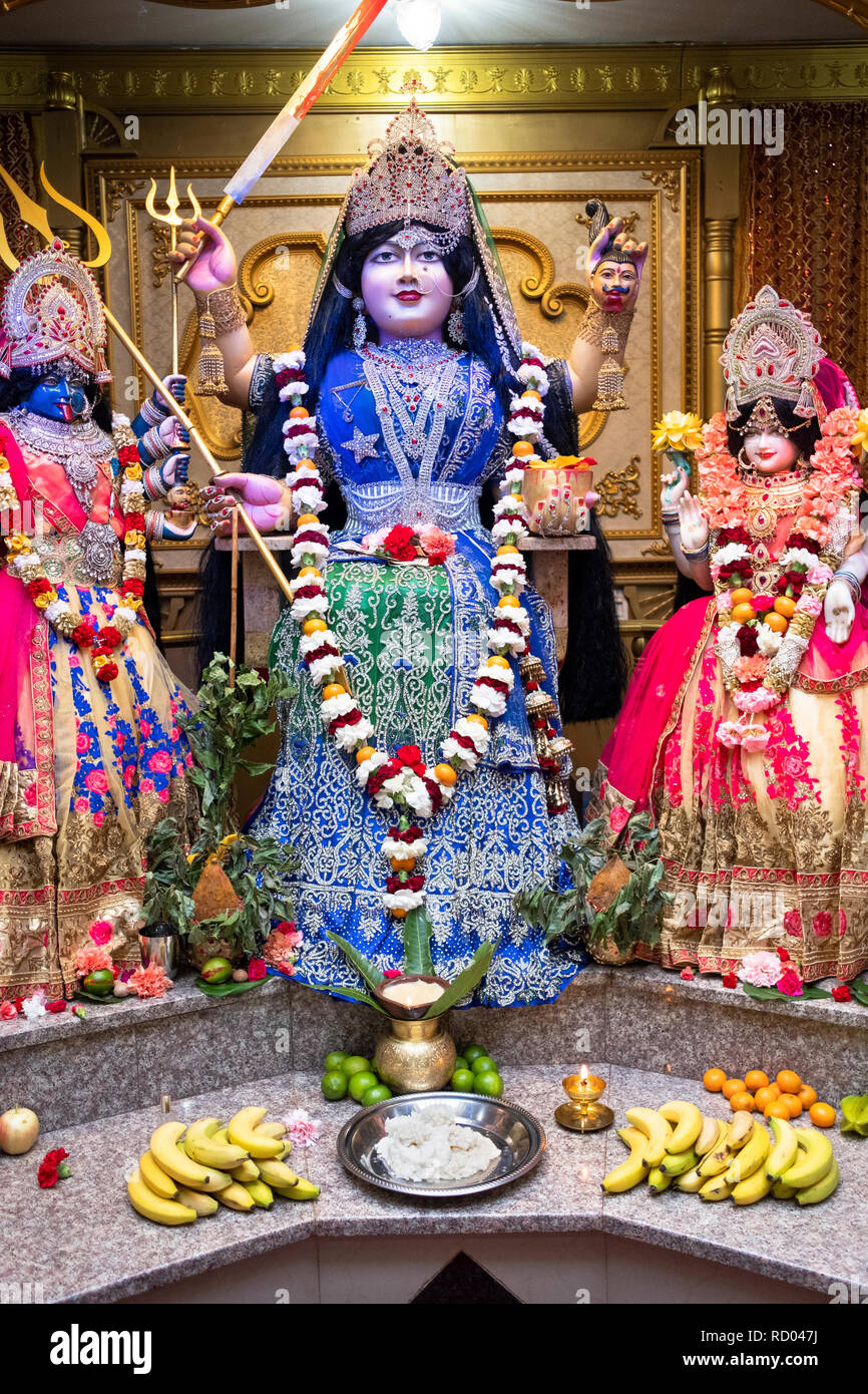 The altar at the Shri Shakti Mariammaa Hindu temple in Queens with several statues of deities. In the center is Mariammaa, the mother goddess. Stock Photo