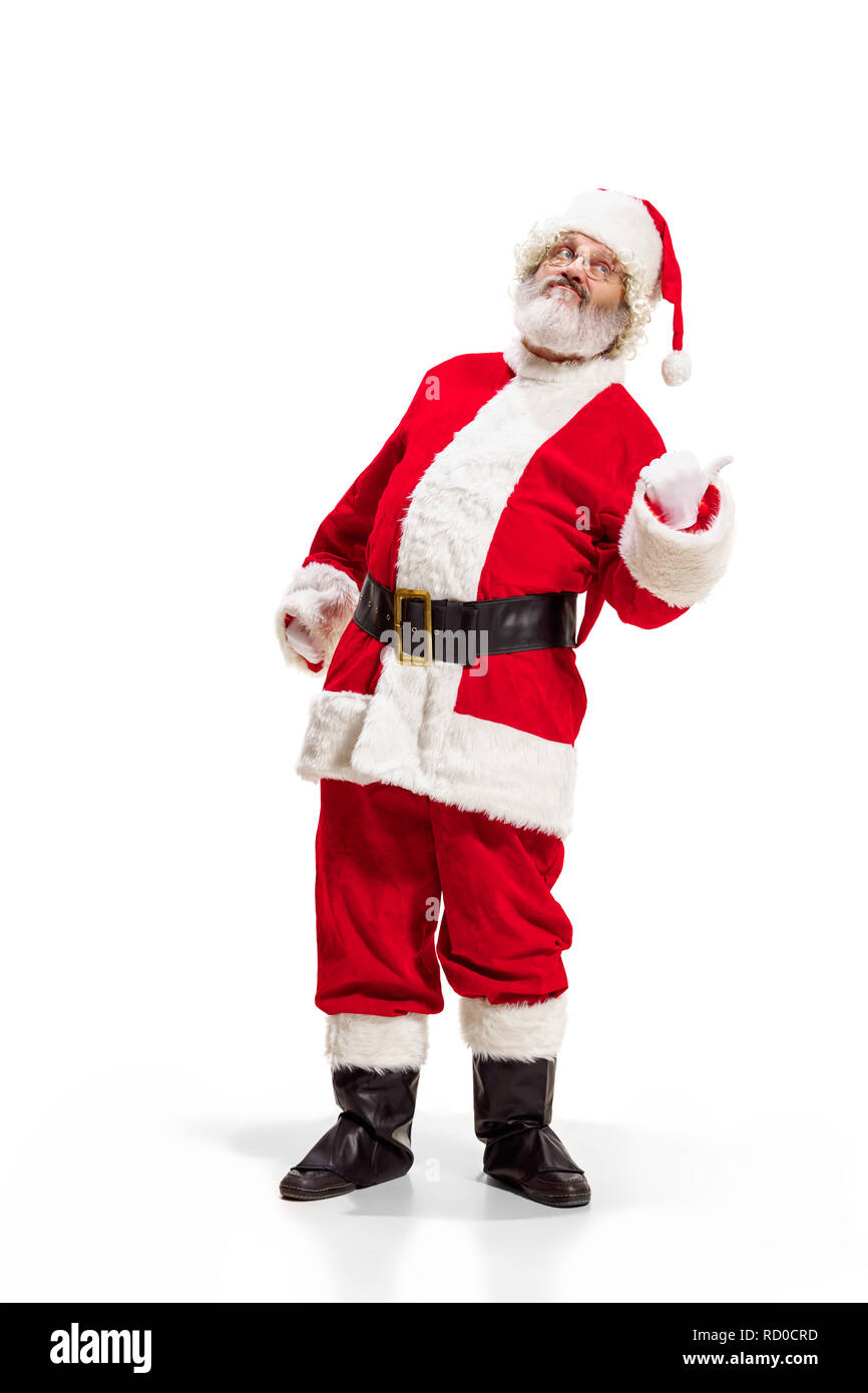 Hey, hello. Holly jolly x mas festive noel. Full length of funny happy santa in headwear, costume, black belt, white gloves, waves with arm palm standing at studio over white background Stock Photo