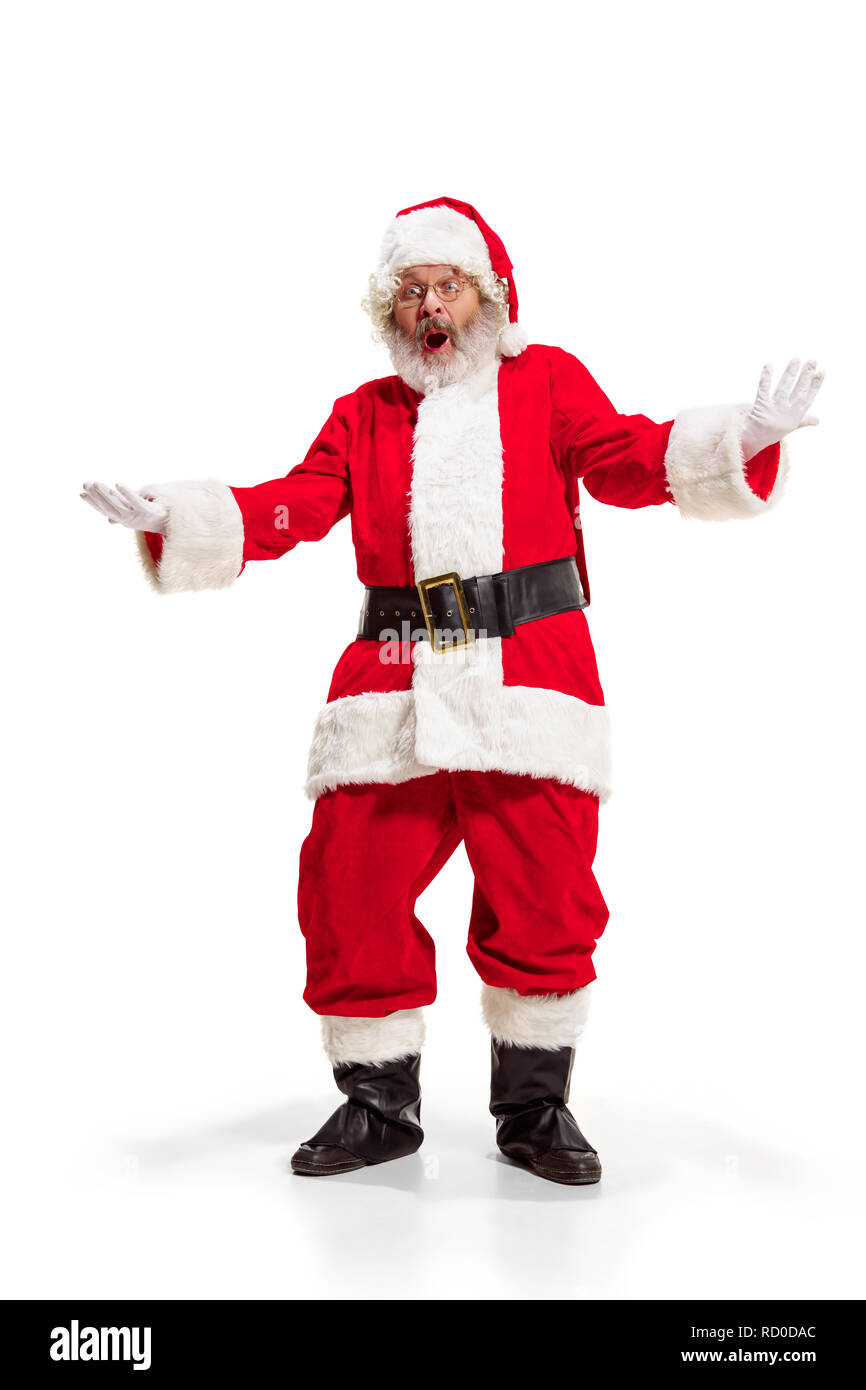 Hey, hello. Holly jolly x mas festive noel. Full length of funny happy santa in headwear, costume, black belt, white gloves, waves with arm palm standing at studio over white background Stock Photo