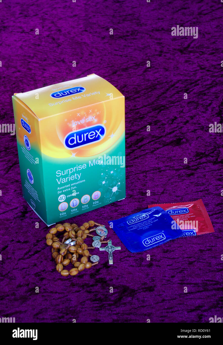 Box of Assorted Durex Rubber Latex Condoms and Roman Catholic Roasary Prayer Beads ( Moral Issues ) Stock Photo