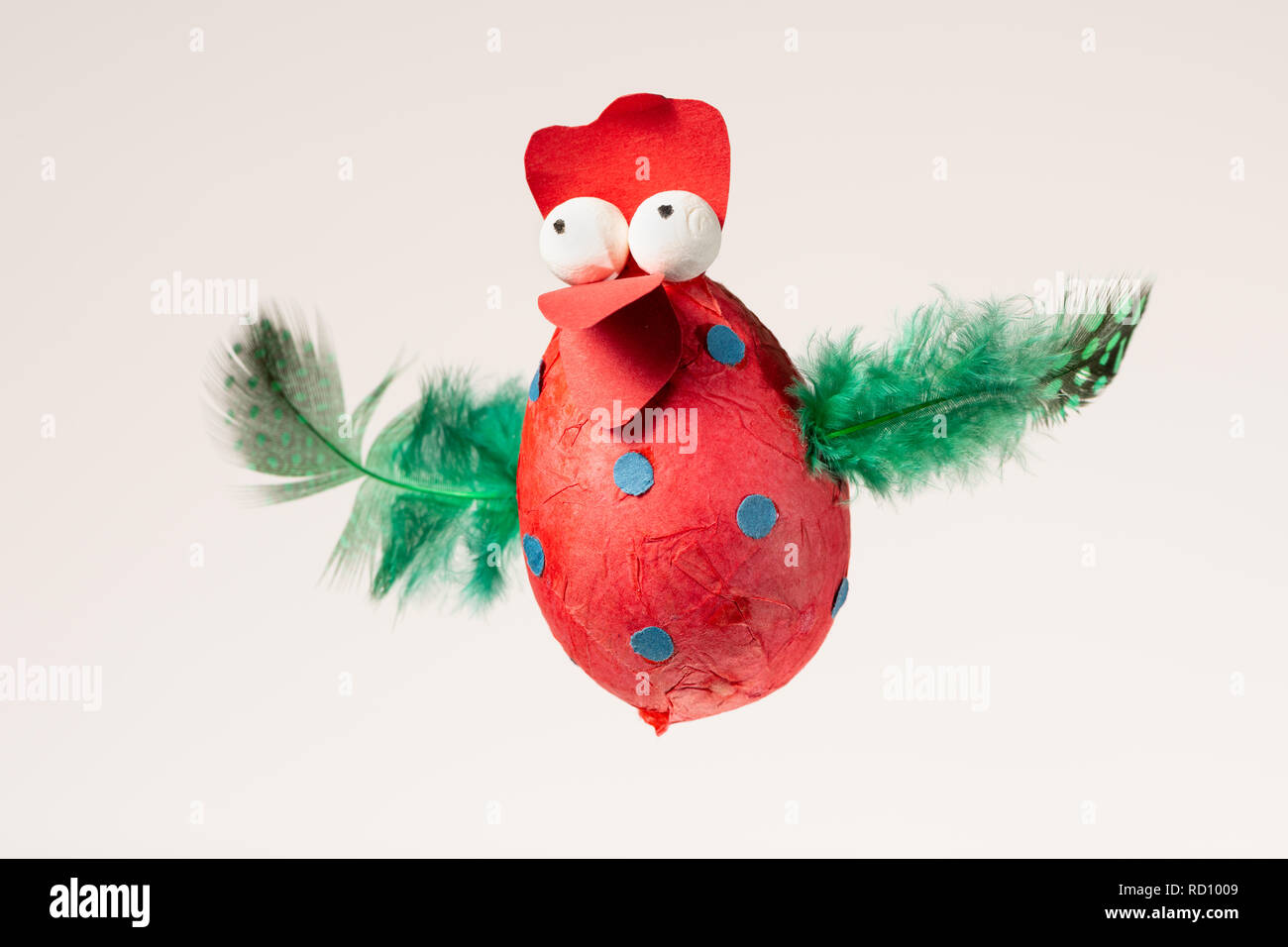 Funny handmade red chicken used for decorating an Easter egg tree, white background Stock Photo