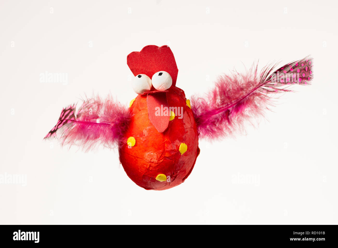 Funny handmade red chicken used for decorating an Easter egg tree, white background Stock Photo
