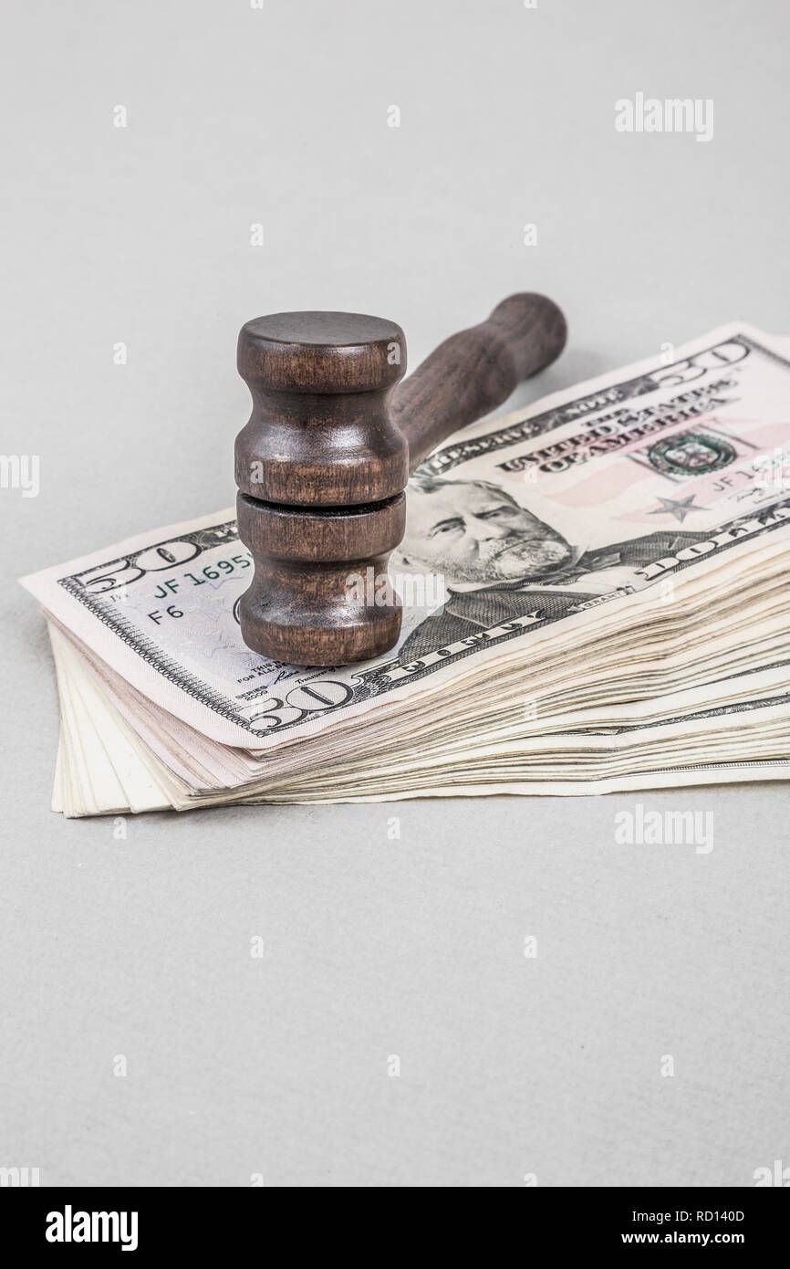 Wooden gavel on American Dollars on grey Stock Photo