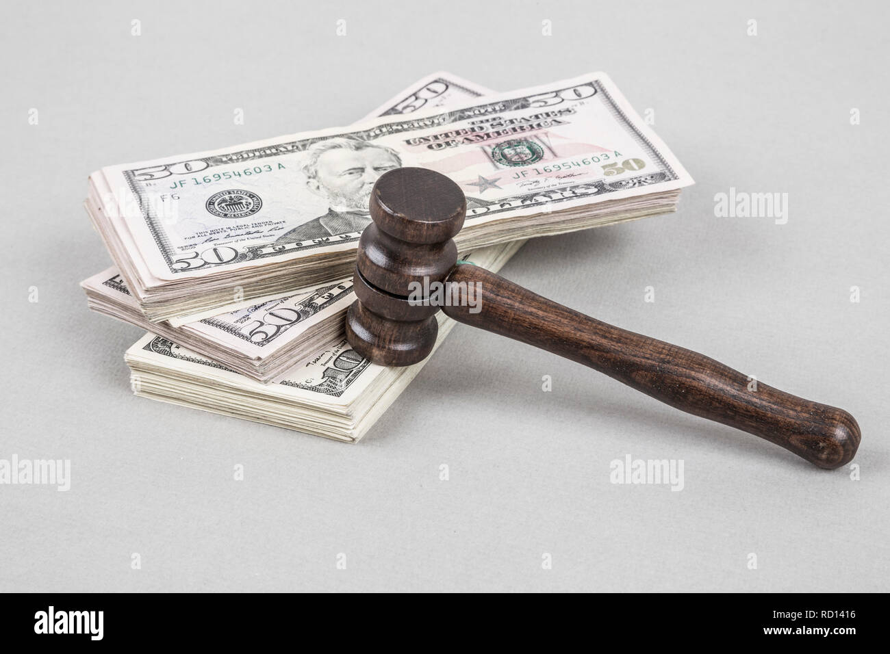 Wooden gavel on American Dollars on grey Stock Photo
